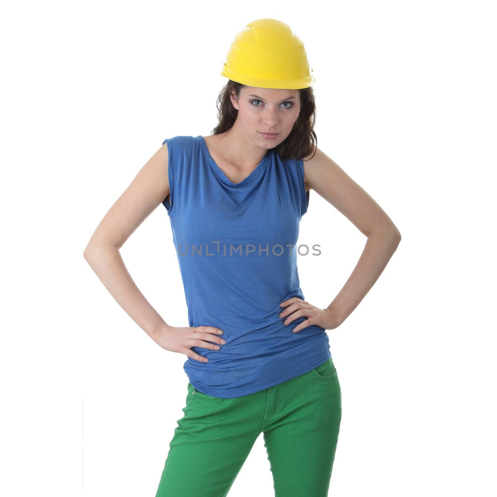 Young female architect or builder wearing a yellow hart hat on a construction site