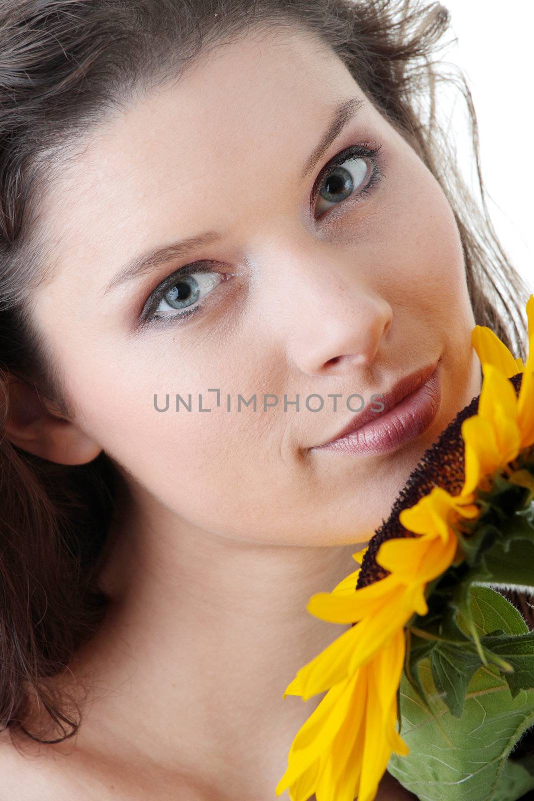 Portrait of a Beautiful girl with sunflower, studio shot over white