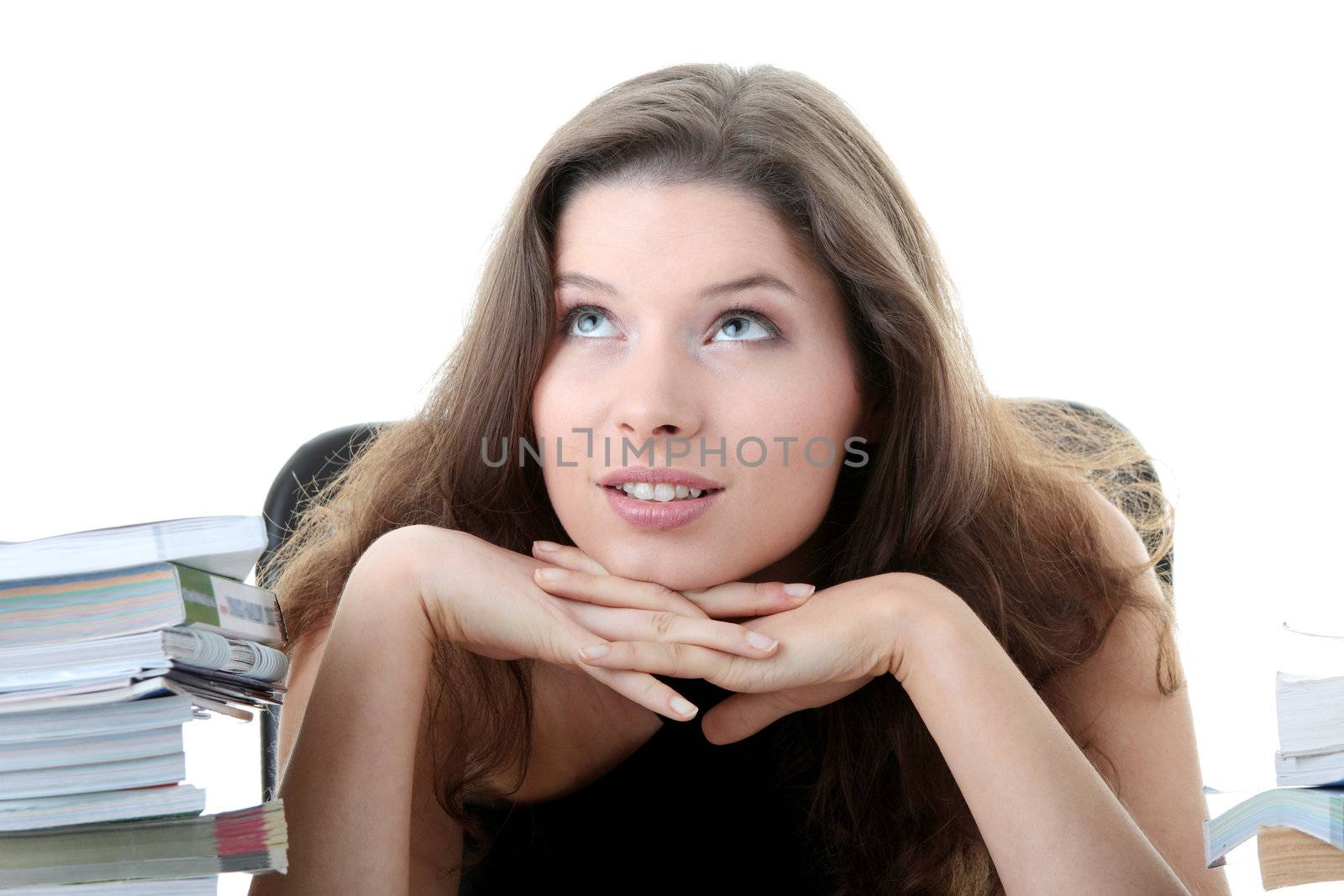 Portrait of young and pretty female student with books around isolated on white background