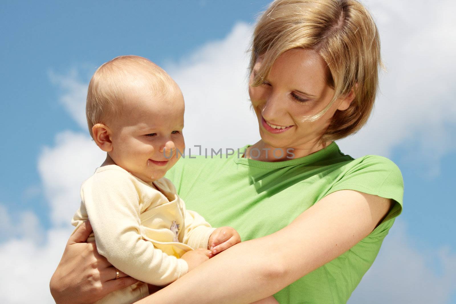 Mother with baby under blue clear sky