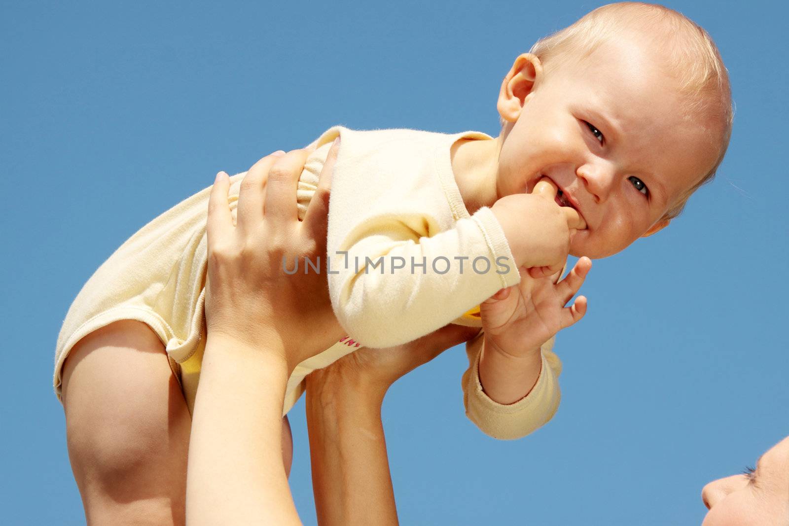 Mother with baby under blue clear sky