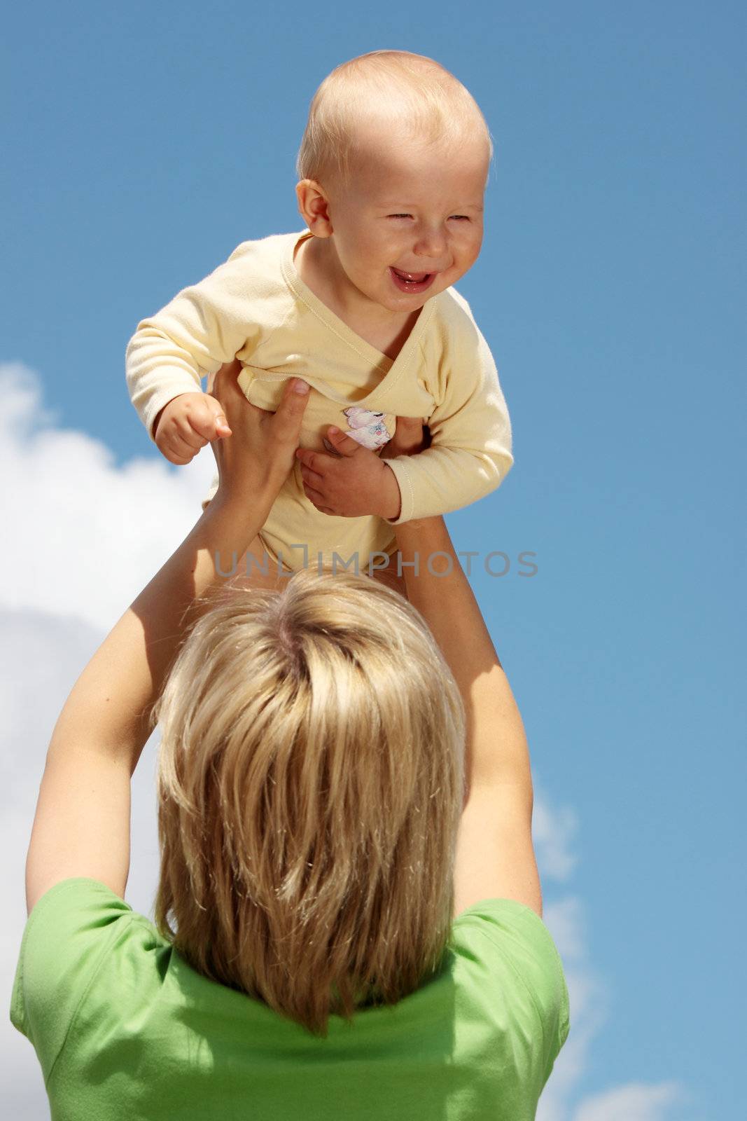 Mother with baby under blue clear sky