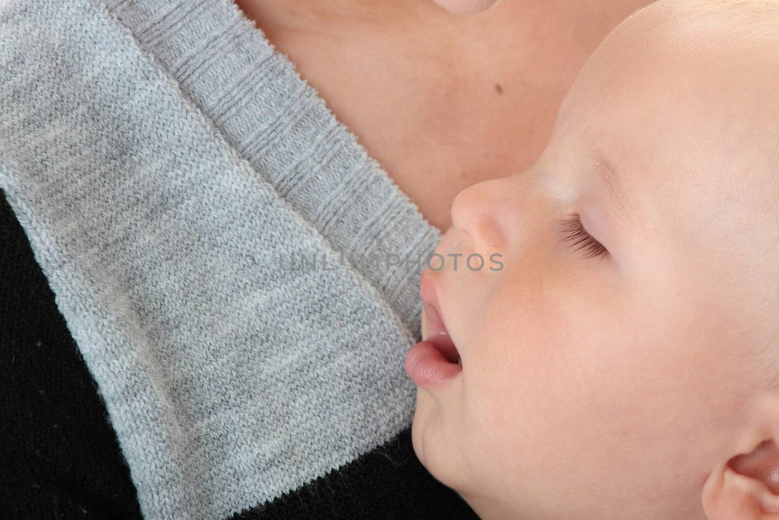 A mother and her tired cute baby boy isolated on white background