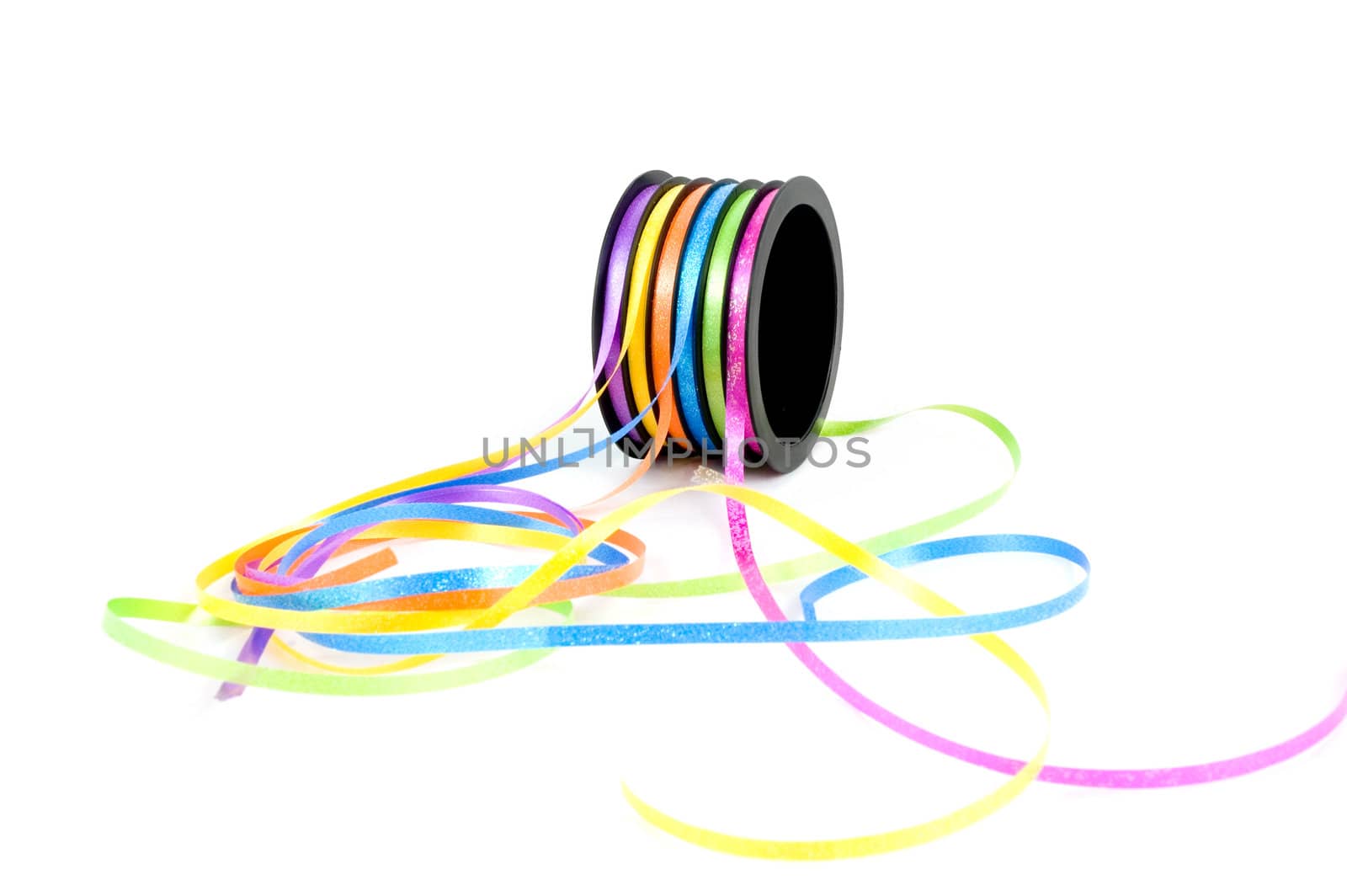 colorful streamers on a role isolated on white background  by ladyminnie