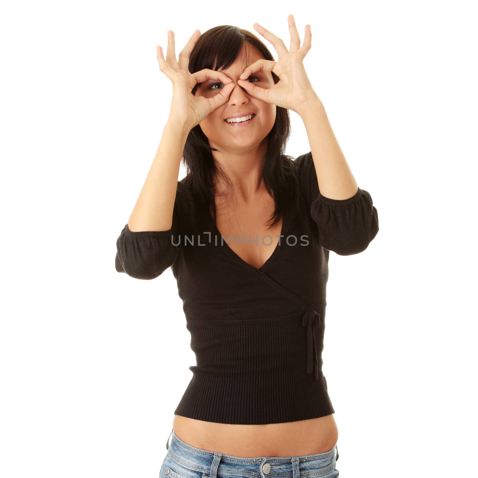 Young casual woman looking through fingers (hands) isolated on white