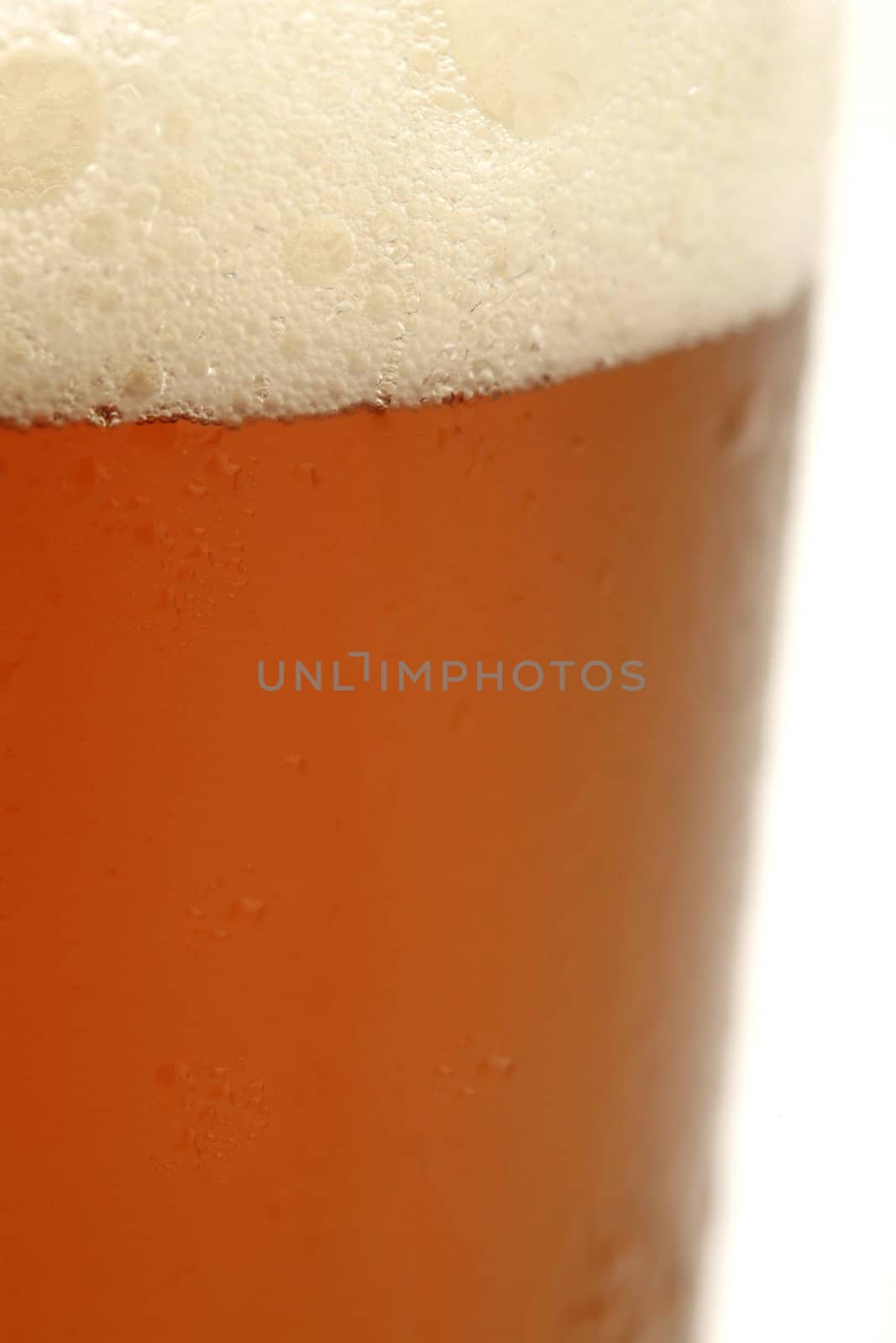 detail of a cold glass of beer with foam
