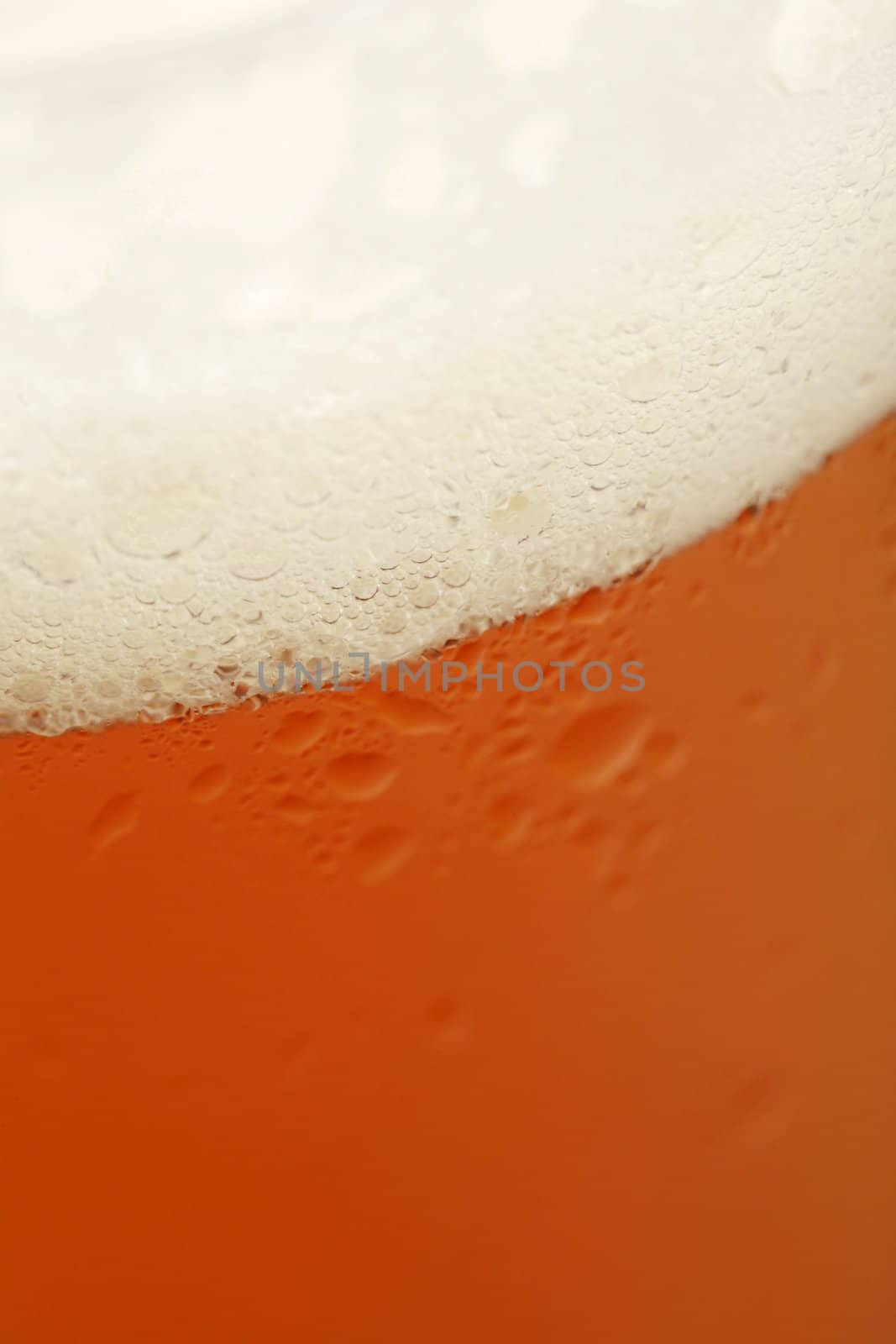 closeup of a cold beer glass with bubbles