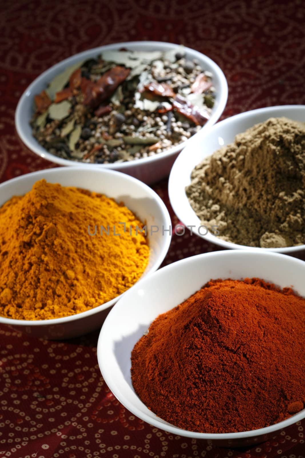 diferent spices in white bowls