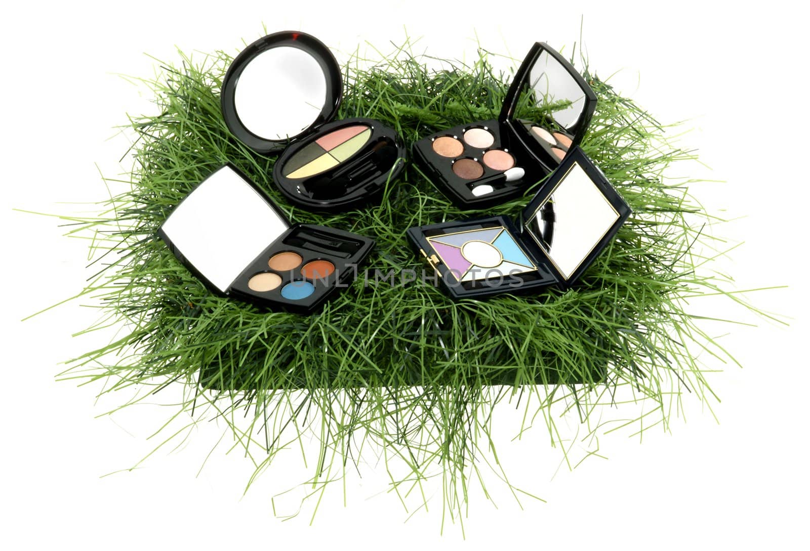 diferent make up in a bascet with grass