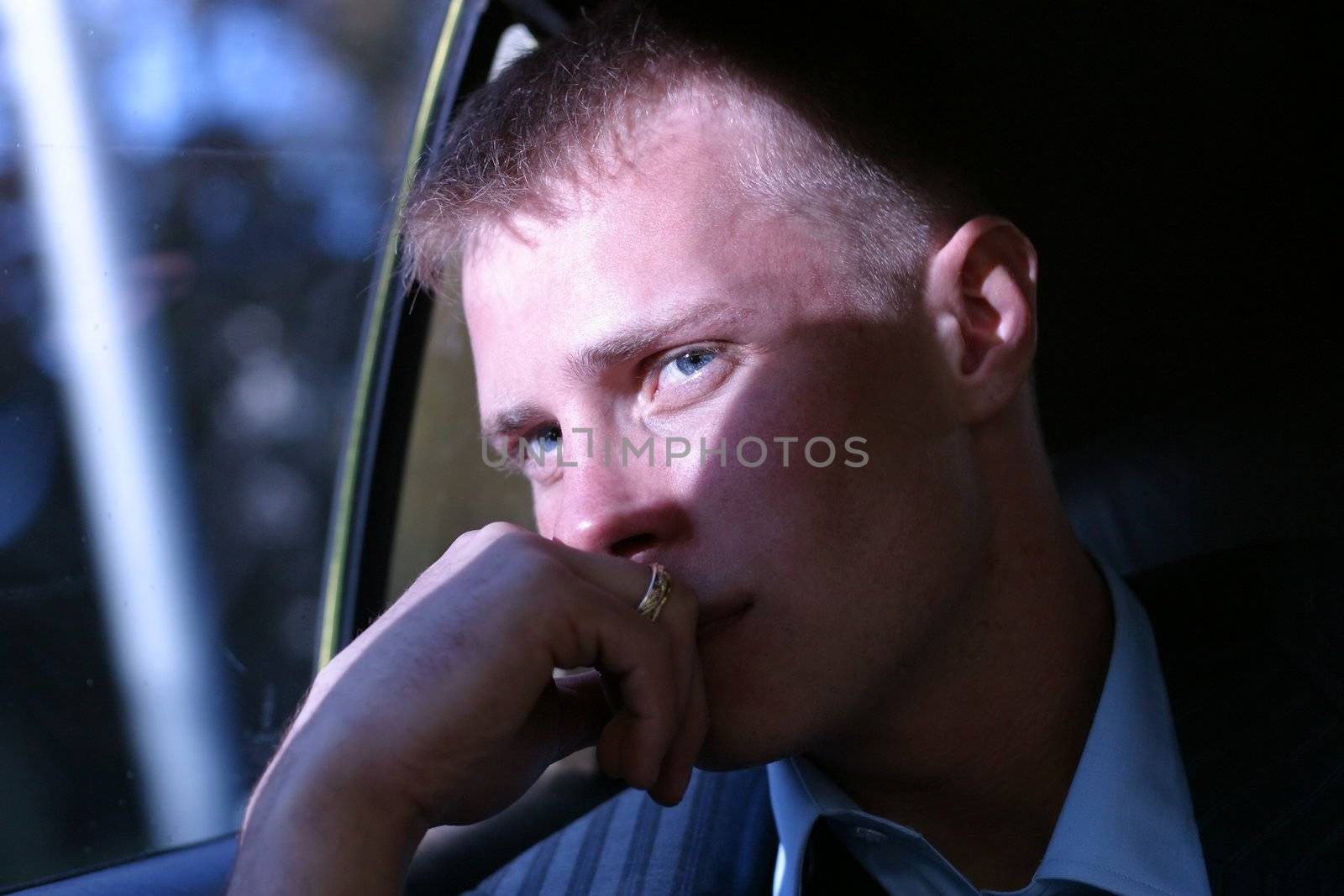 The young man looking to the left in a hand at face covered by the sun