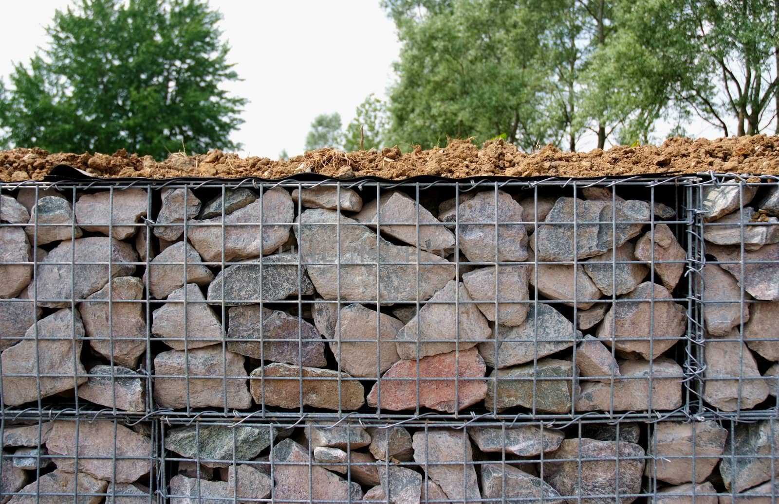 Metal cages with stone inside, used for building and shoring up of an embankment for example a motorway or for forming a sea defence or the like.