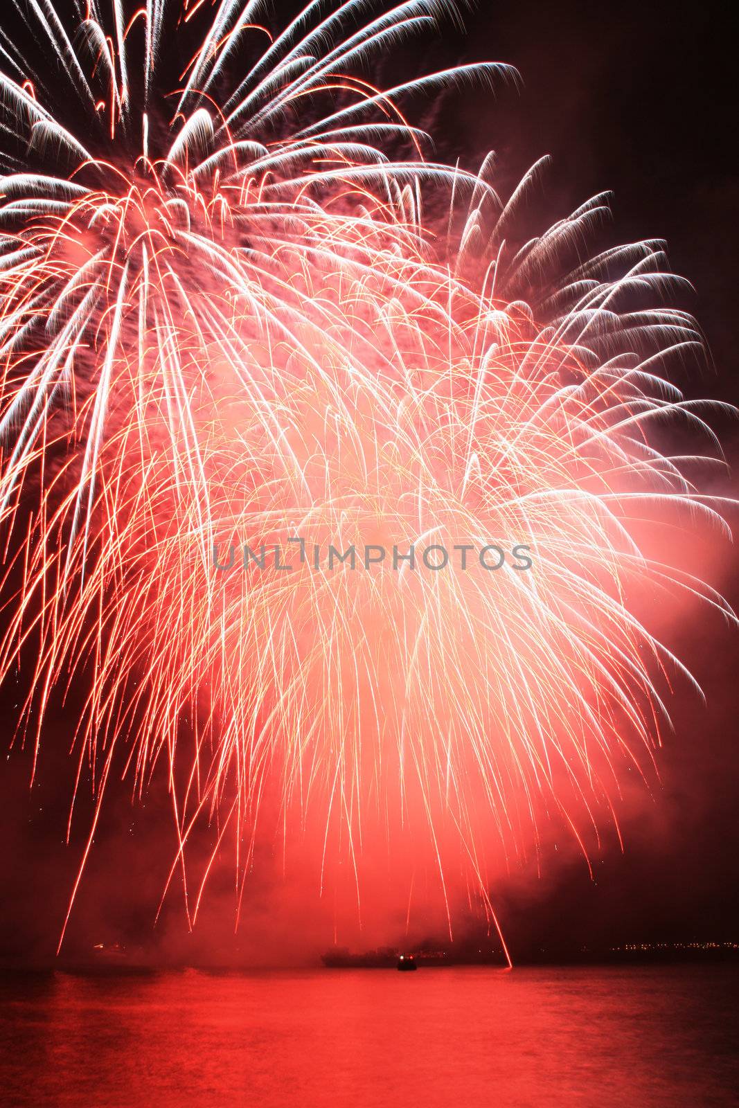 bright red pompom fireworks against the sky
