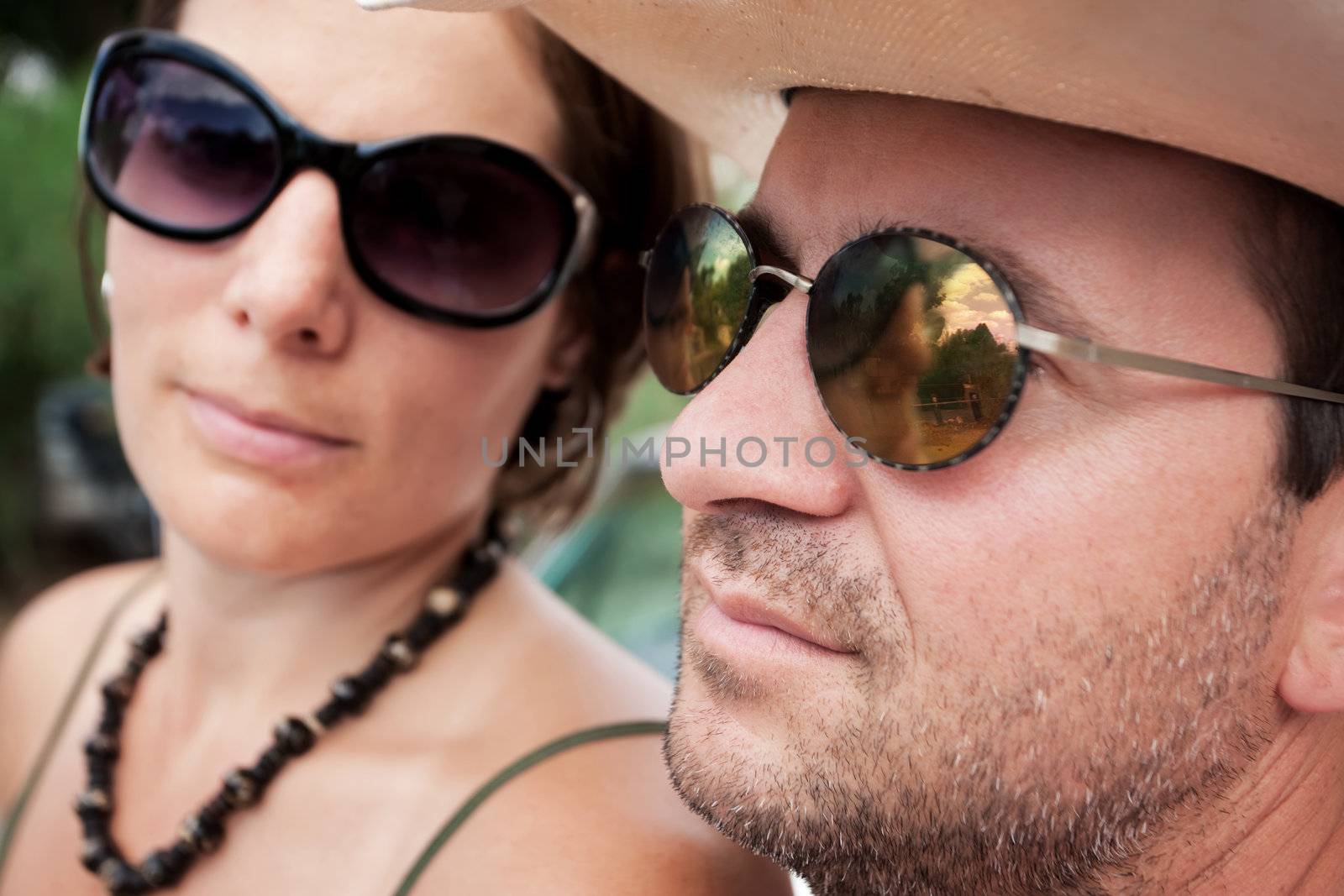 Attractive adult couple wearing fashionable sunglasses