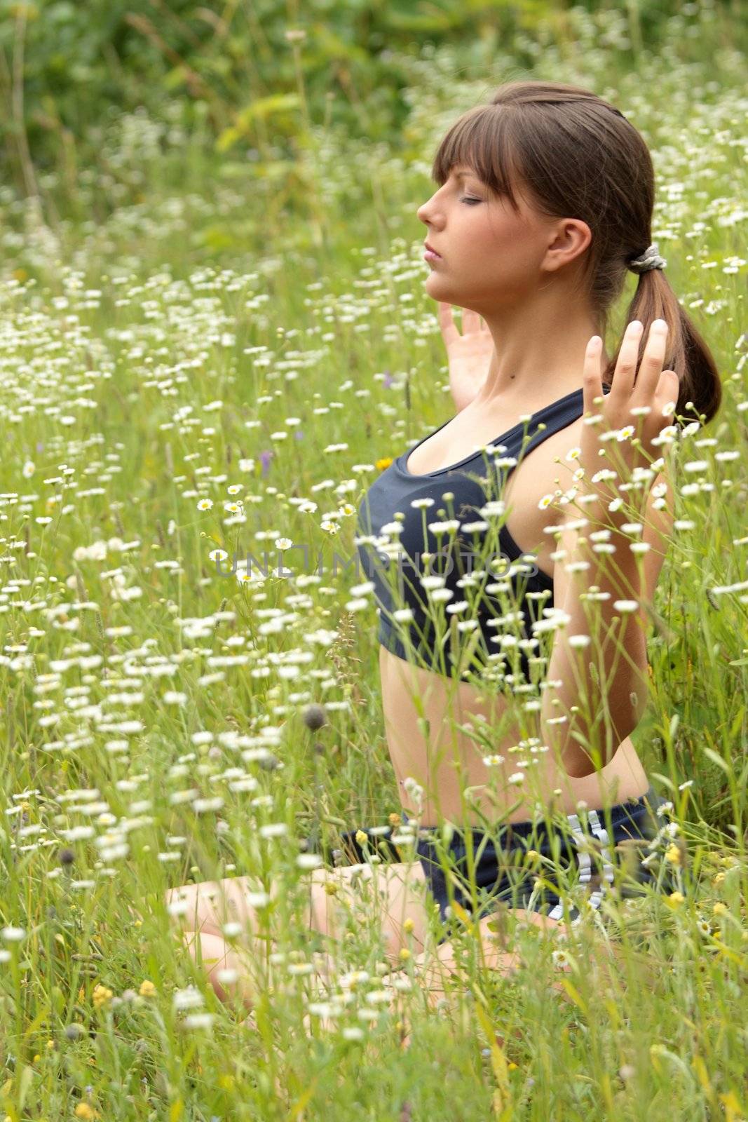 A young woman doing yoga by BDS