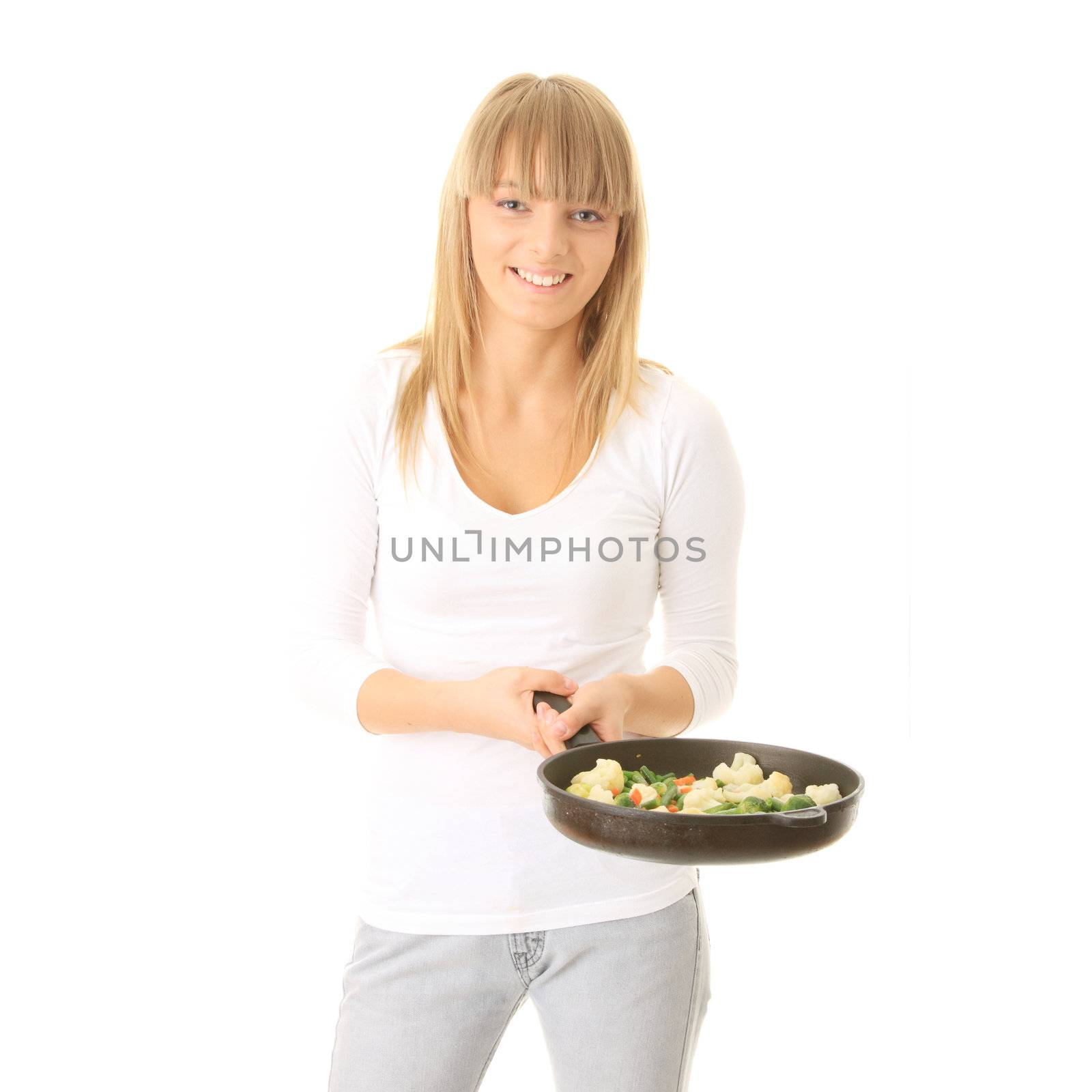 Image of a young woman cooking healthy food in the kitchen