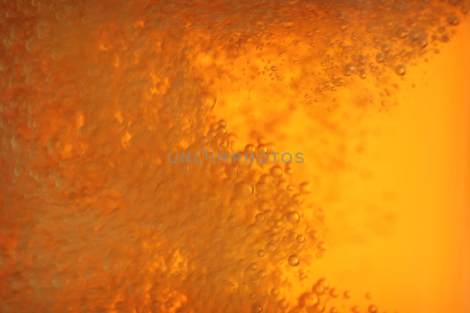 closeup of beer bubbles in motion