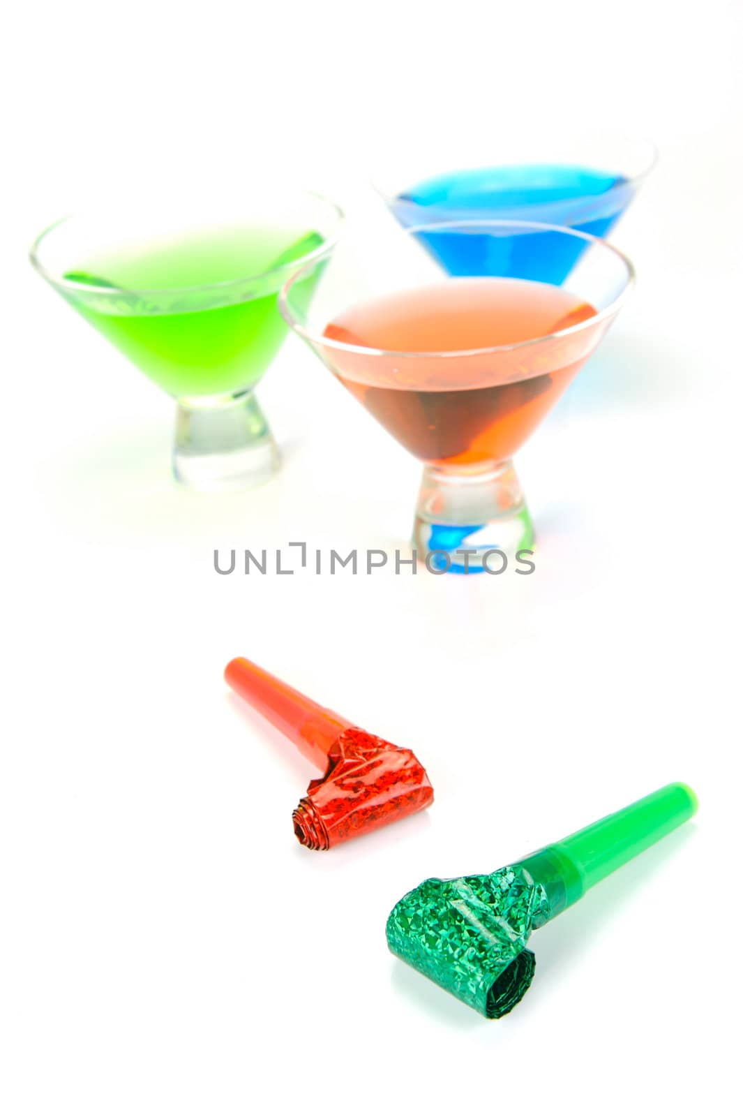 Cosmopolitan cocktails and party favours isolated against a white background