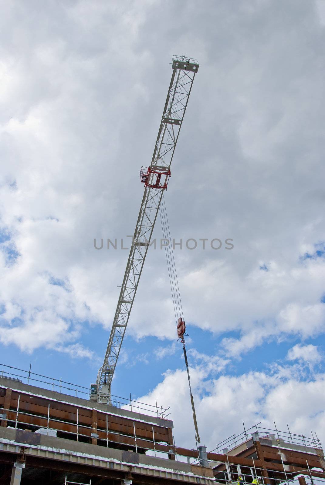 The Jib of a white Construction Crane on a shopping mall site