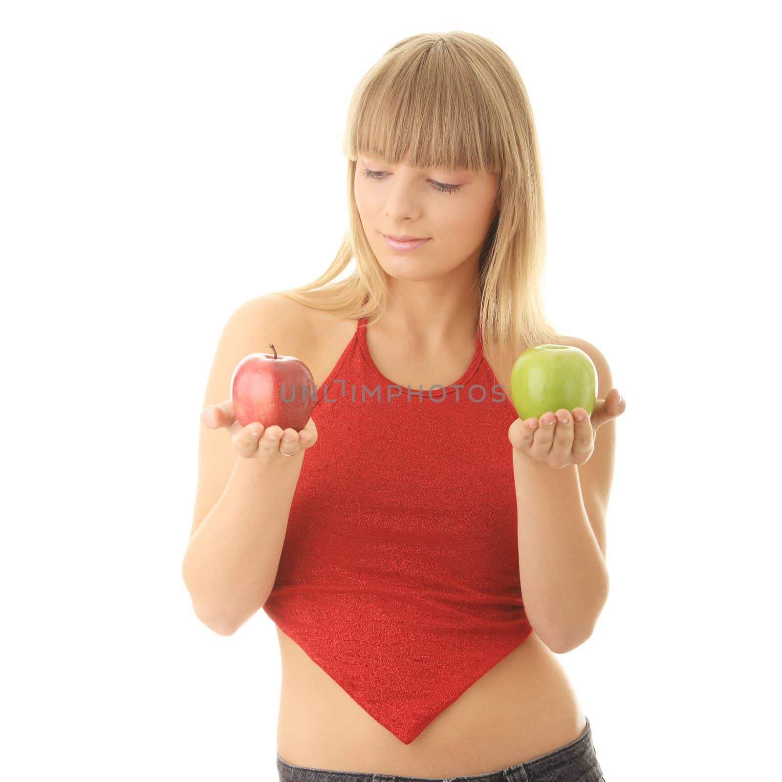 Young blond woman with red and green apples on her hand - making decision concept