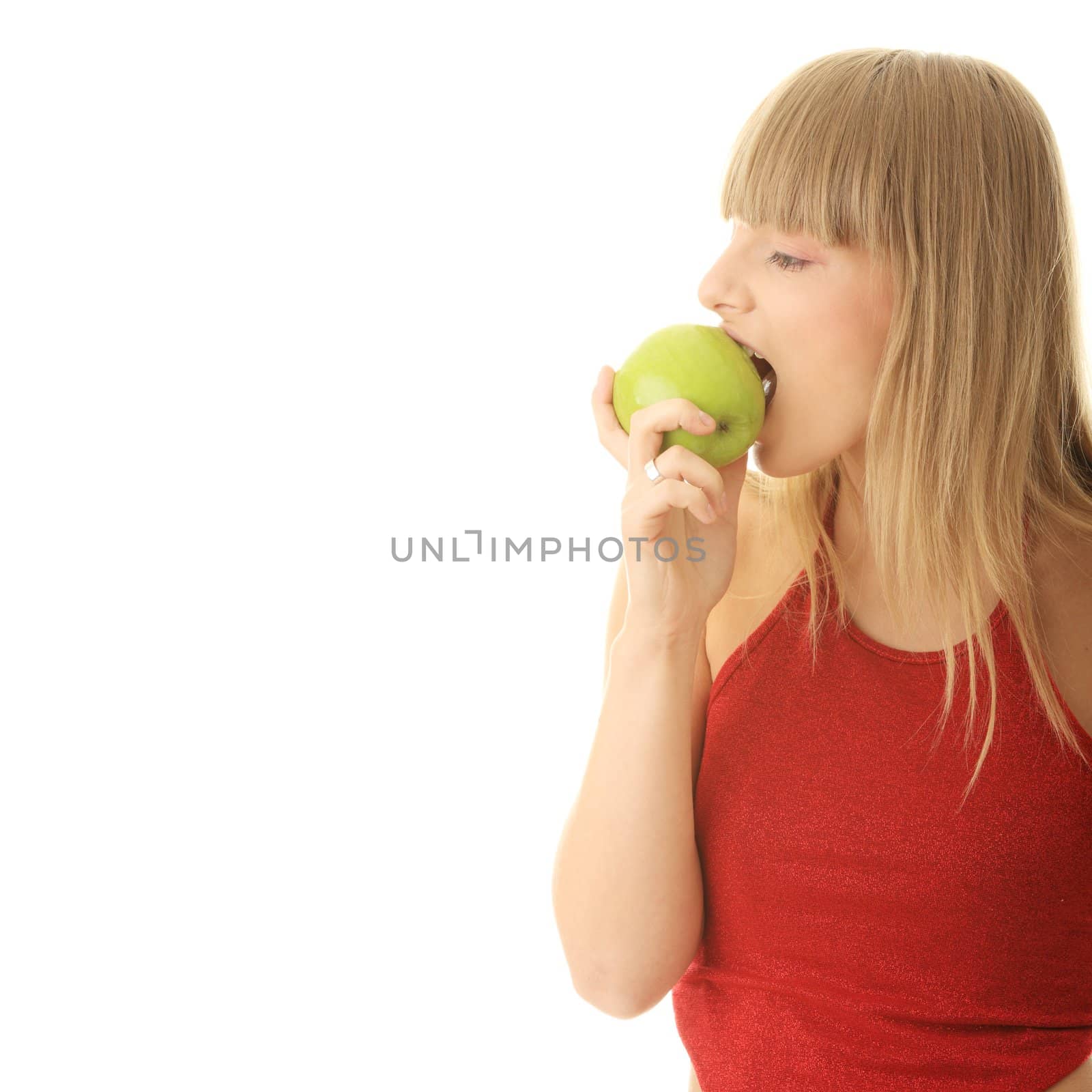 Young blond woman with green apple isolated on white background - healthy concept