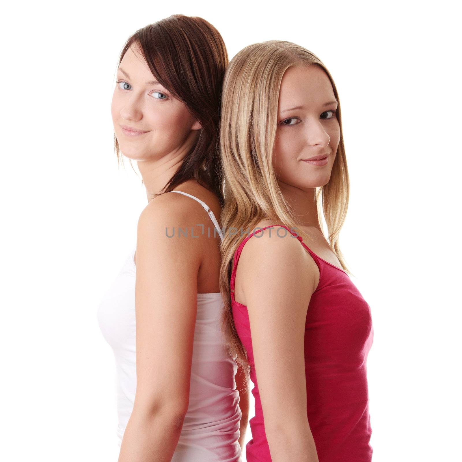 Two young fitness woman standing isolated on white