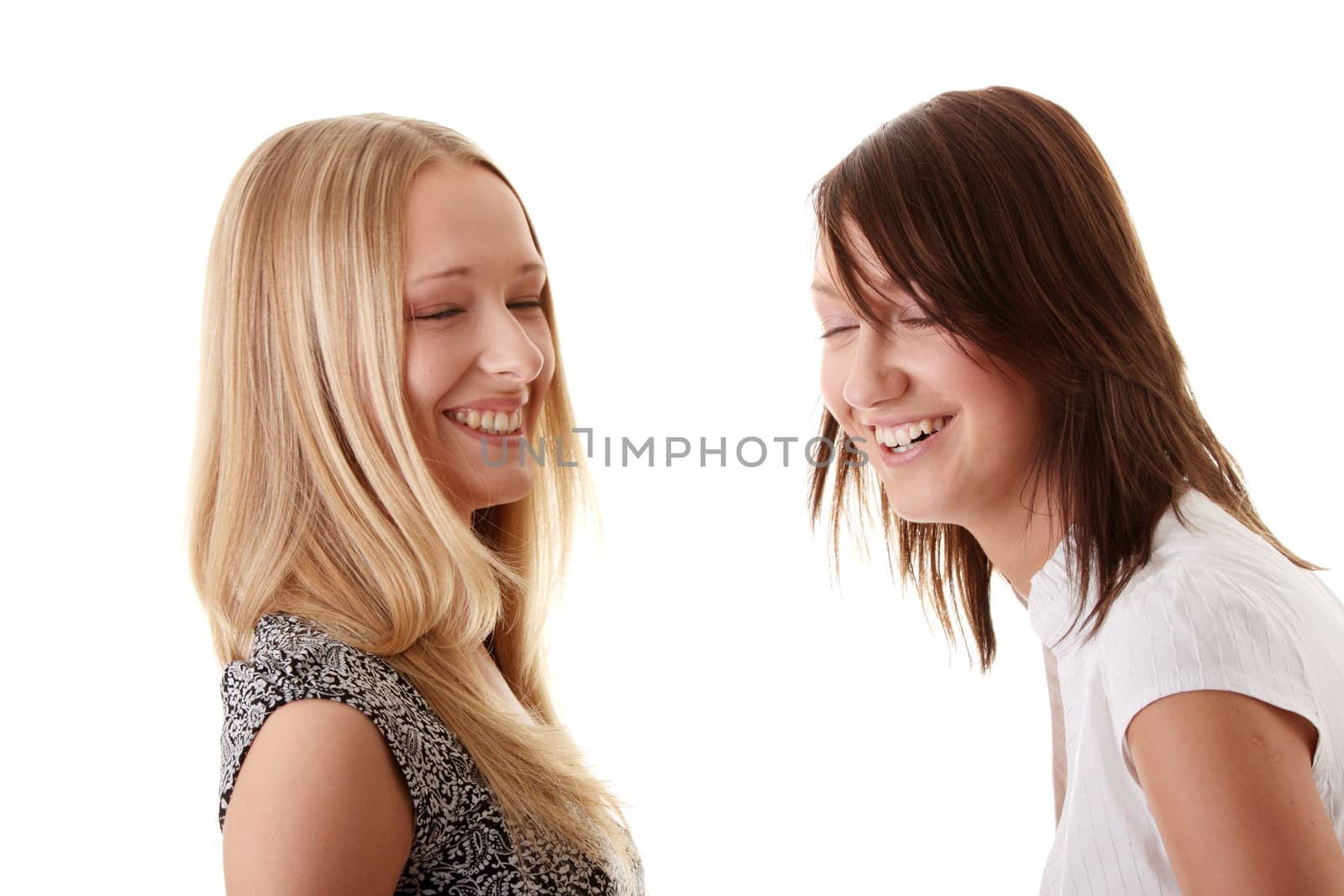 Happy young women friends laughing. Isolated over white background