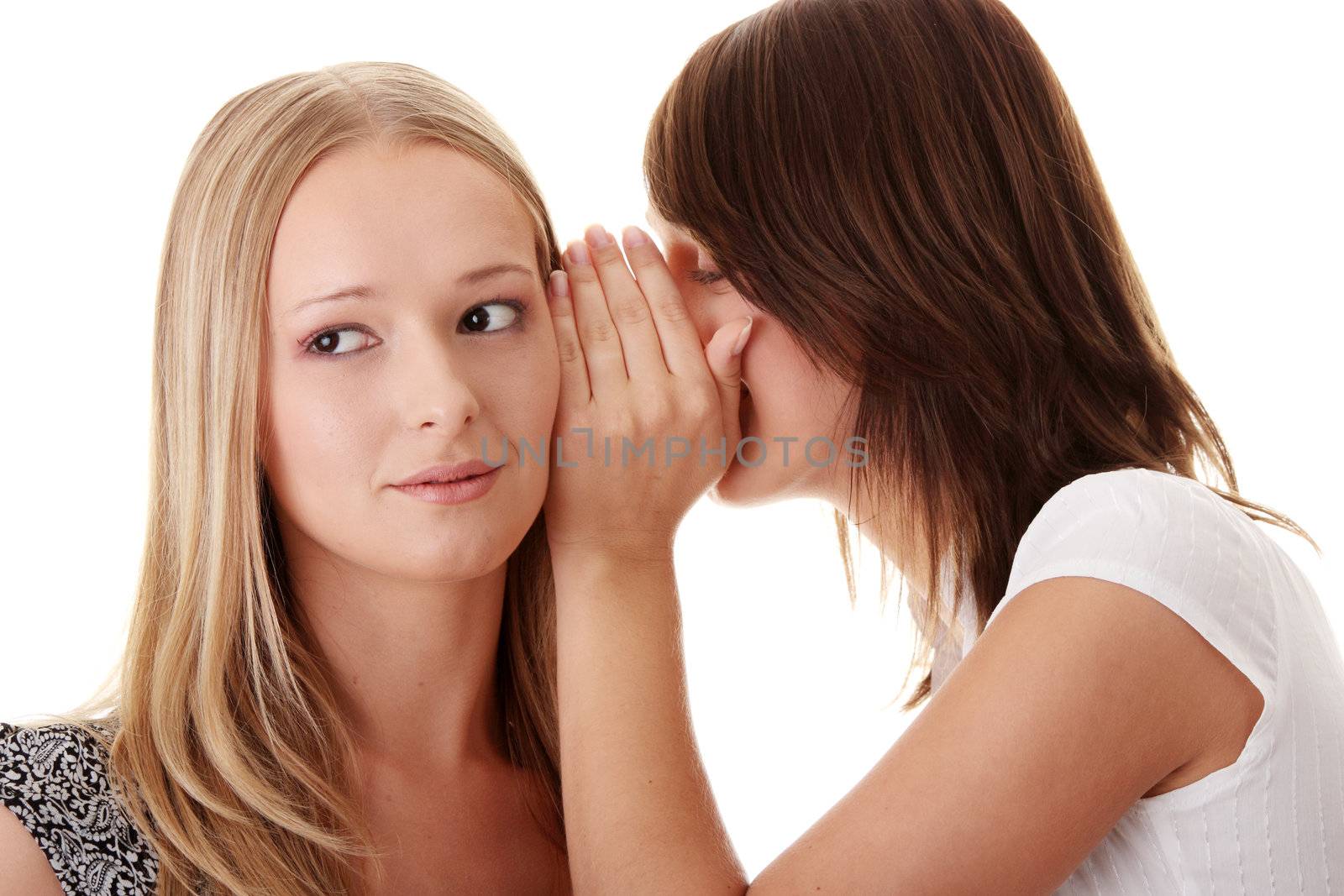 Two young casual caucasian woman gossiping isolated against white background