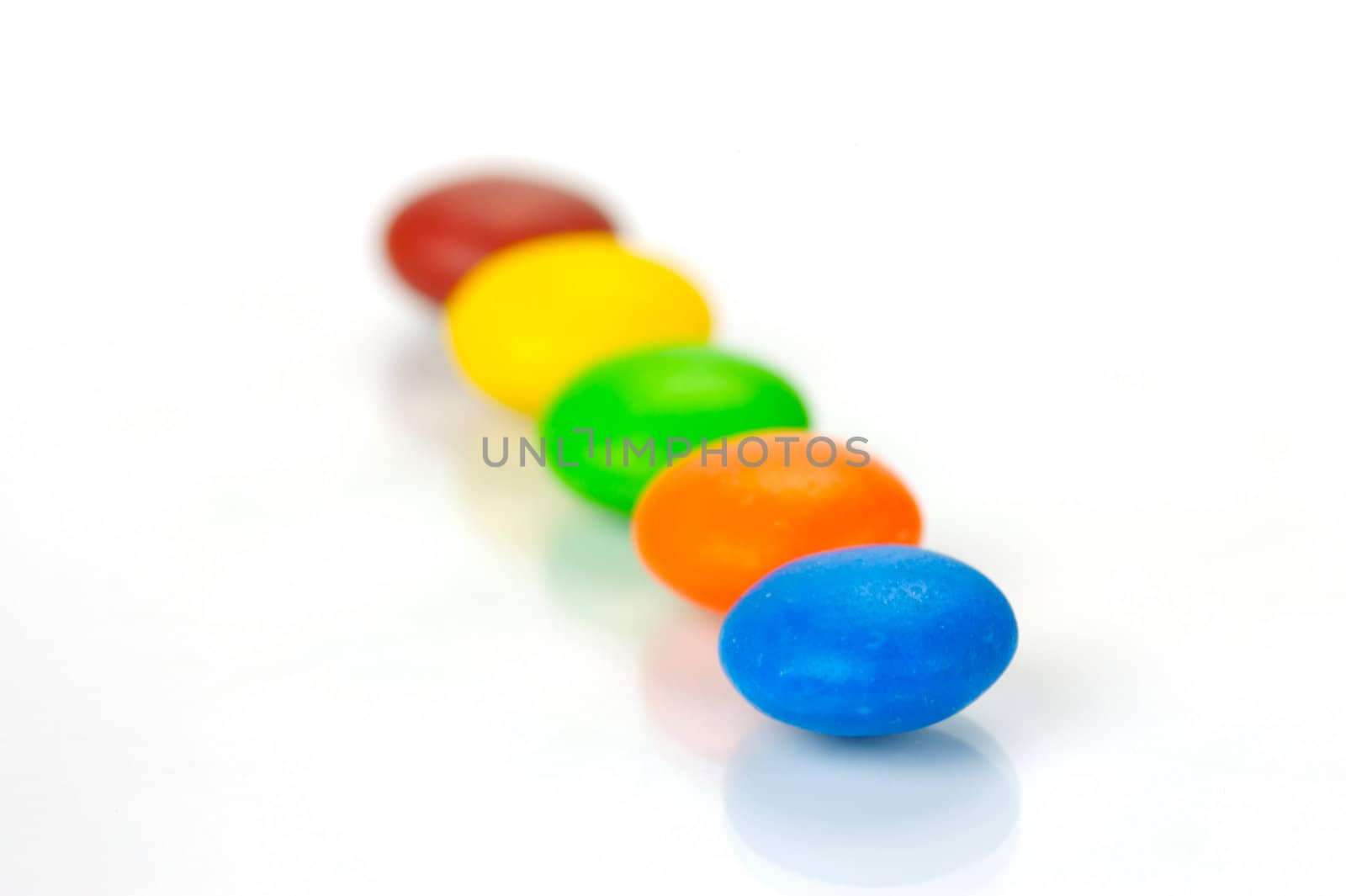 Chocolate coated candy isolated against a white background