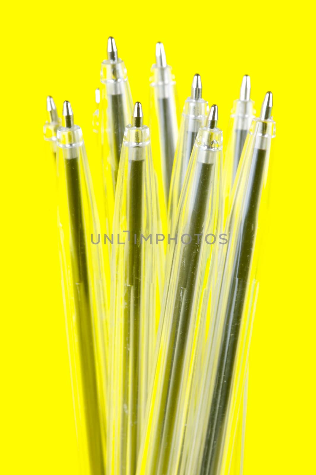 Ball point pens isolated against a yellow background