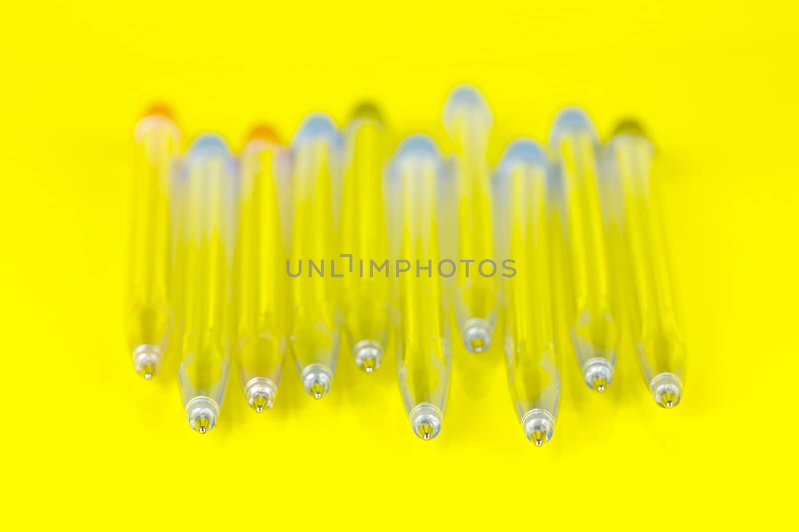 Ball point pens isolated against a yellow background