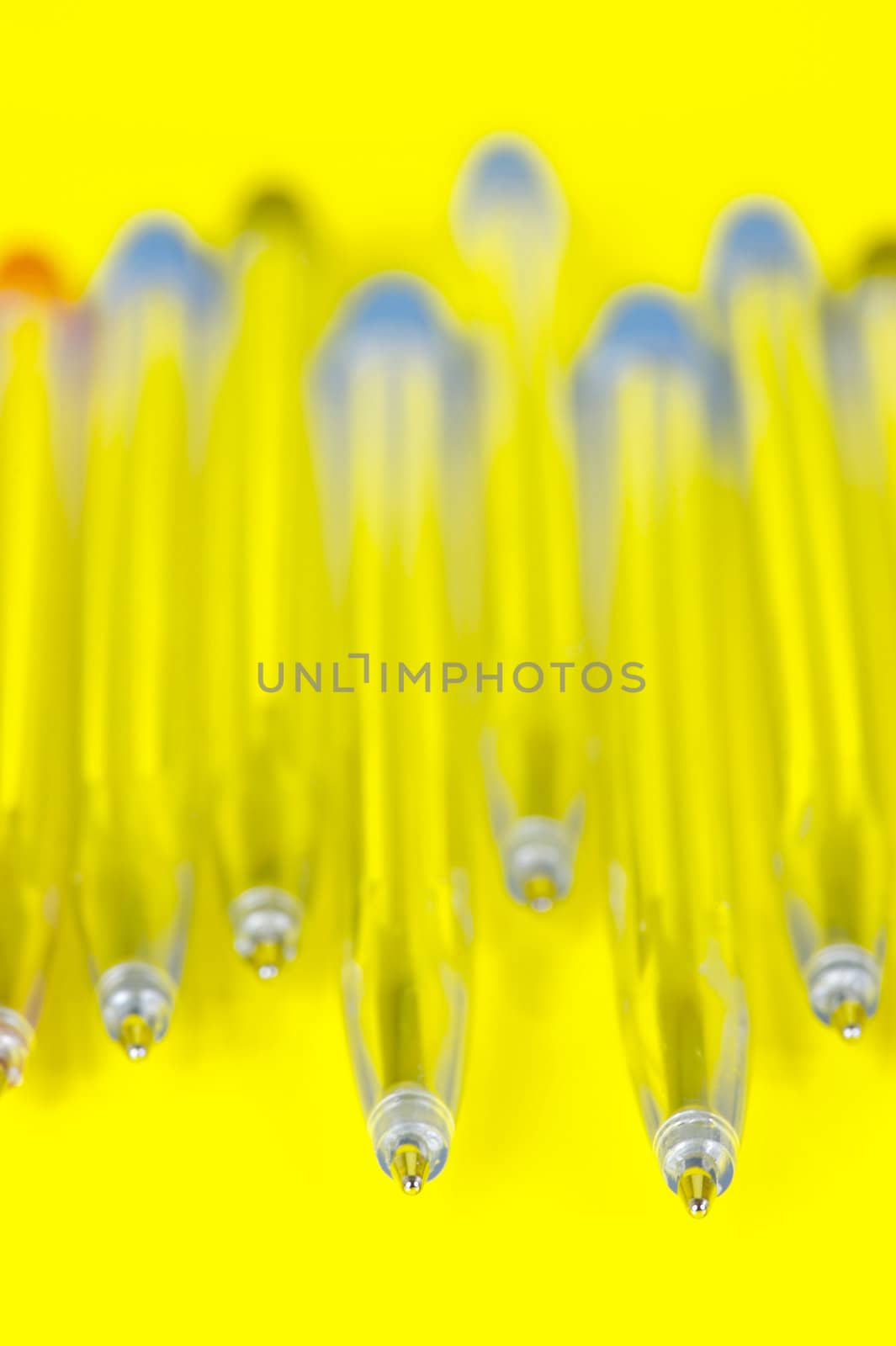 Ball point pens isolated against a yellow background