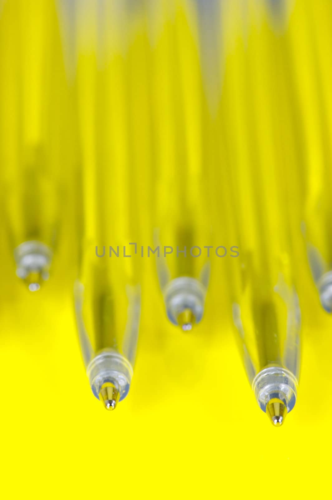 Ball point pens isolated against a yellow background