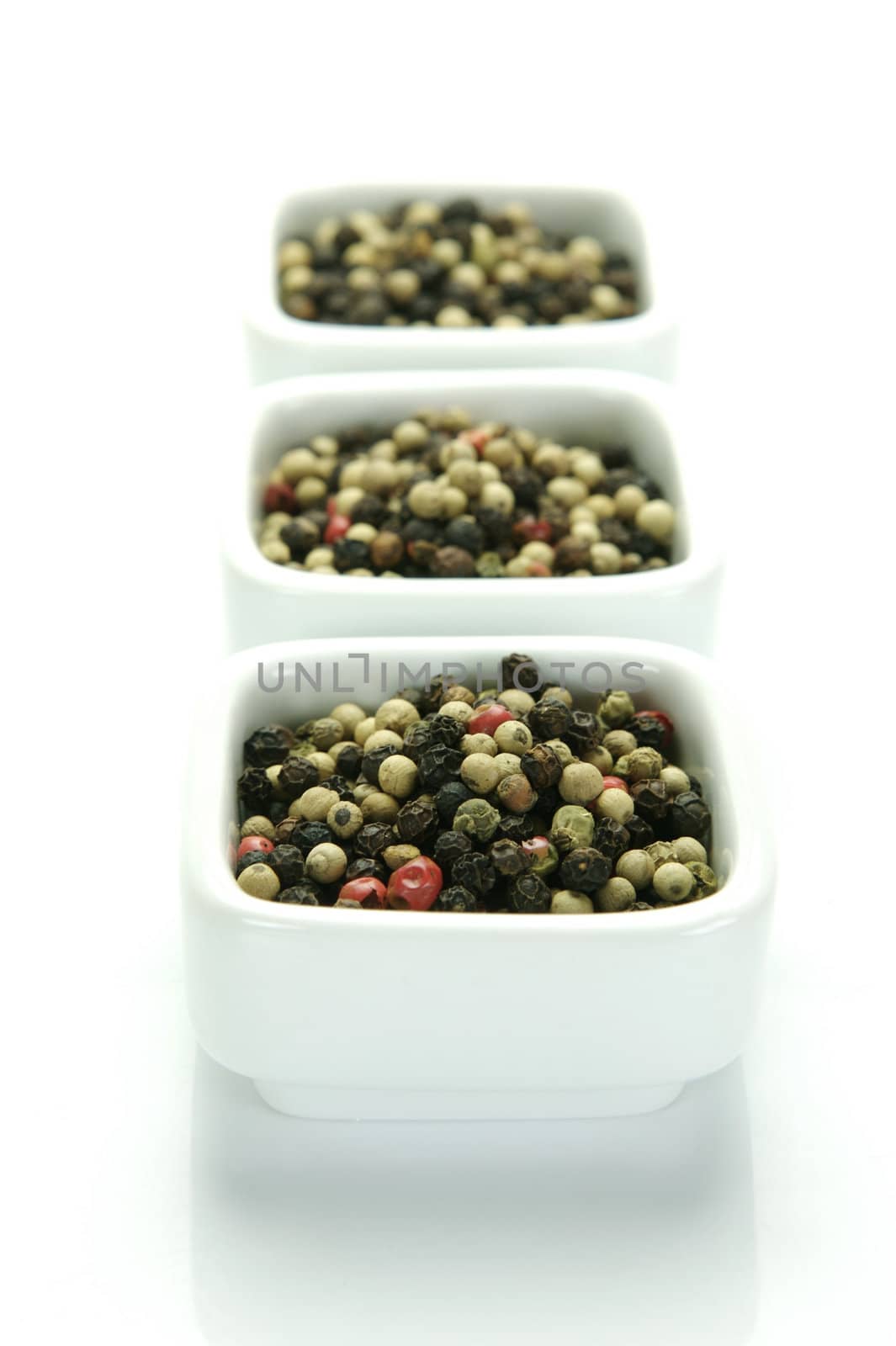 A close up shot of mixed pepper corns mixed together