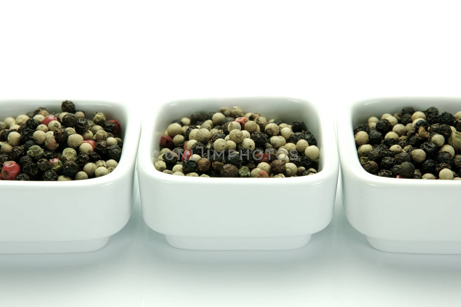 A close up shot of mixed pepper corns mixed together