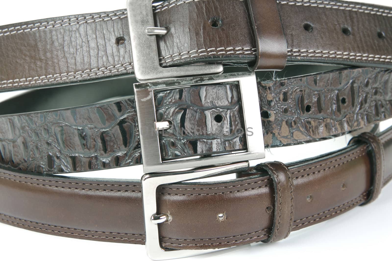 Brown belts isolated against a white background
