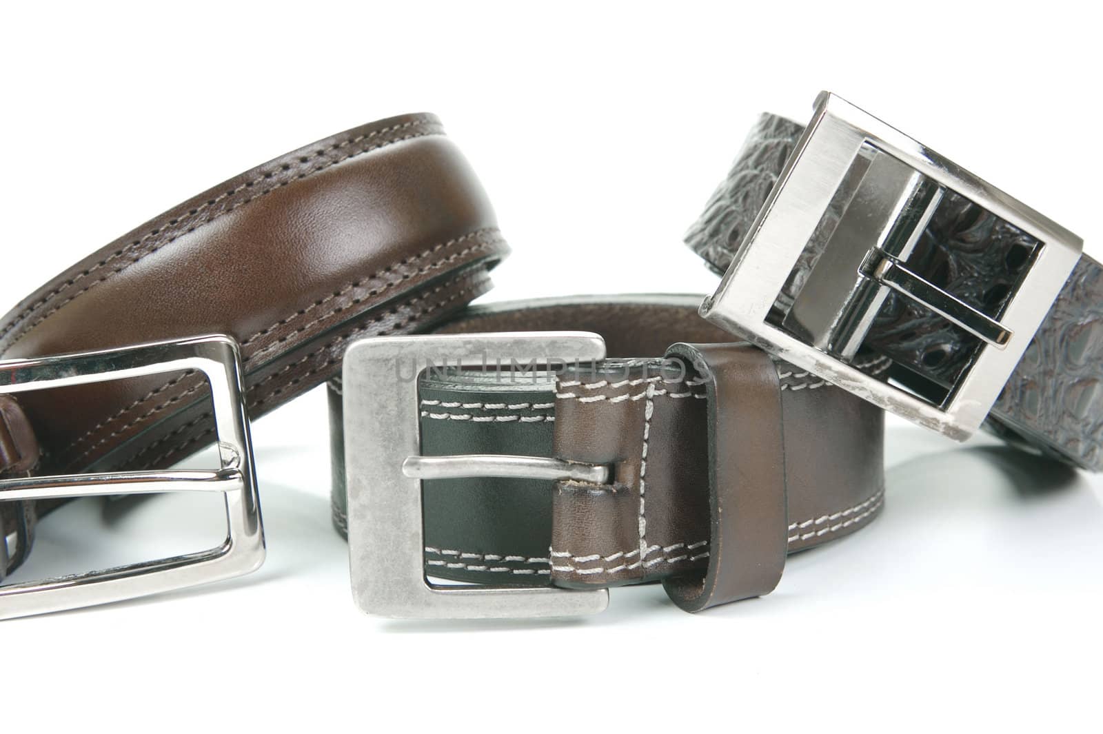 Brown belts isolated against a white background