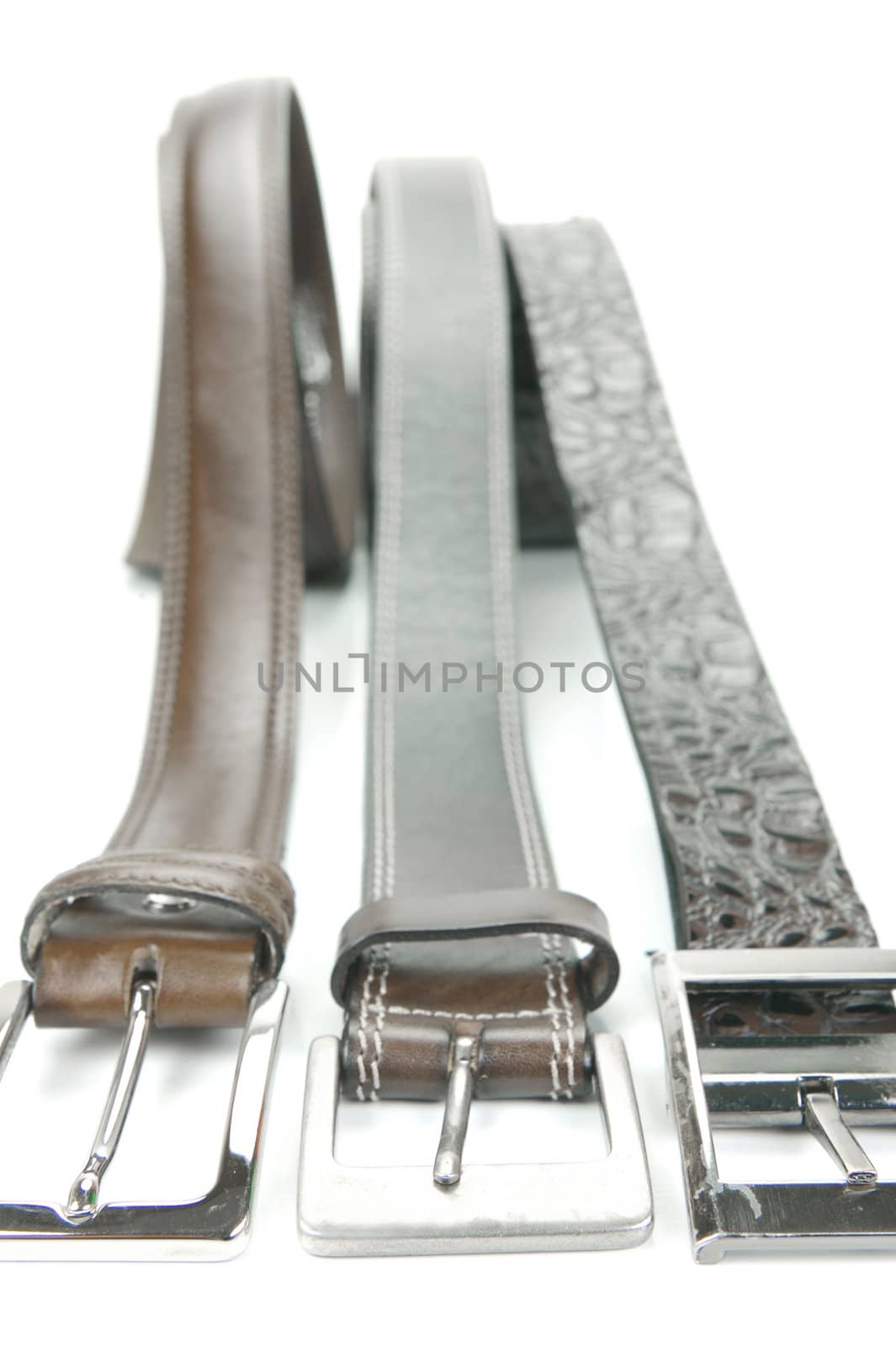 Brown belts isolated against a white background