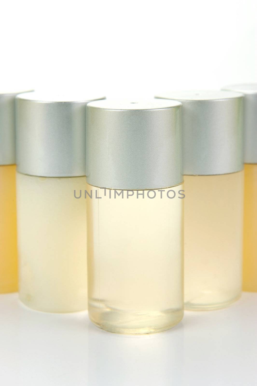Miniatureshampoo bottles isolated against a white background