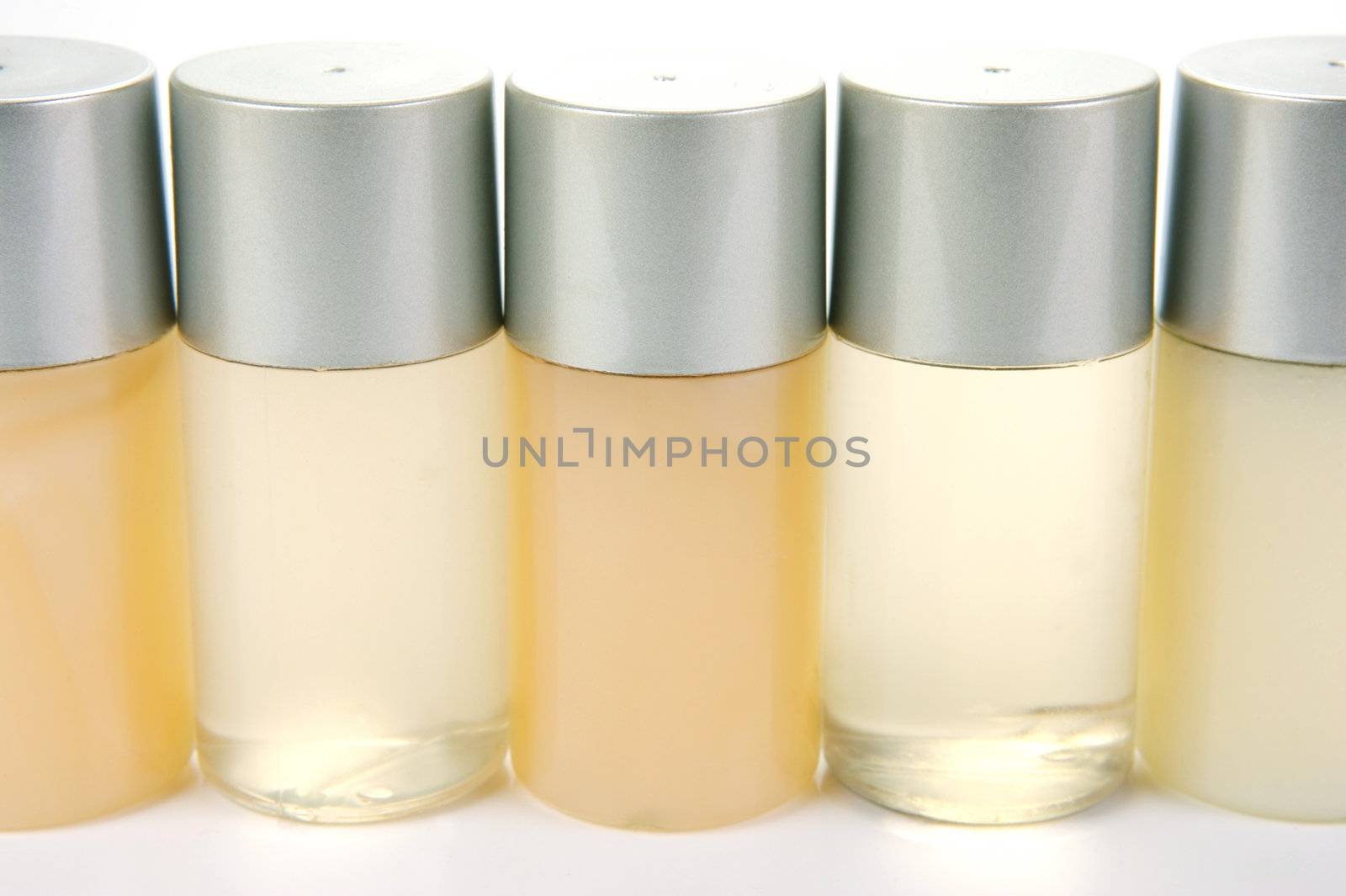 Miniatureshampoo bottles isolated against a white background