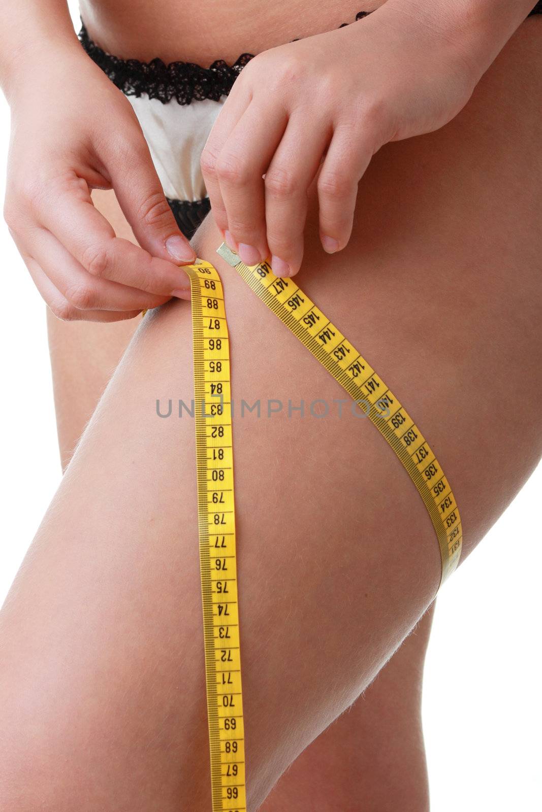 A little bit fat young woman mesuring her body isolated on white background