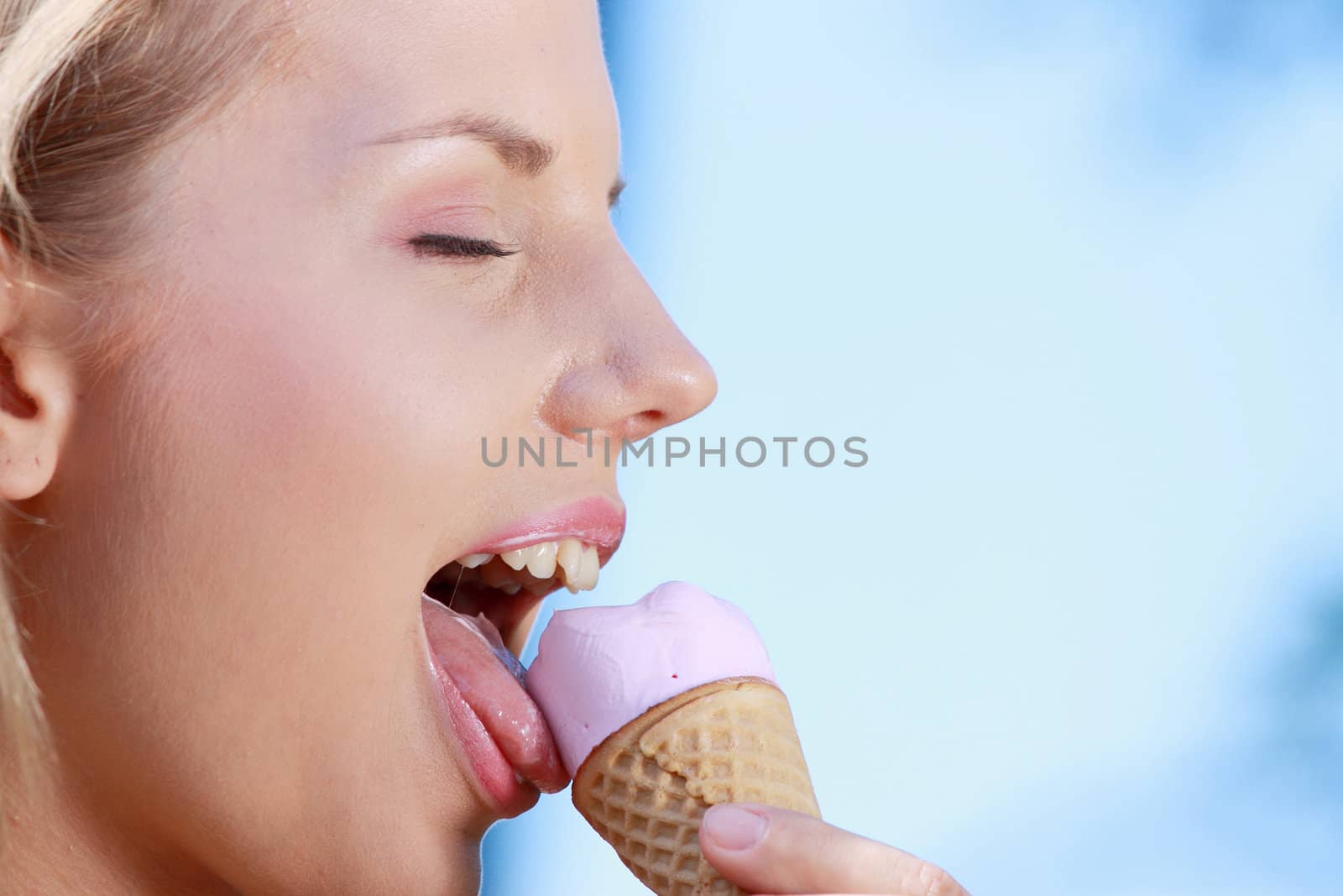 Portrait of young happy woman eating ice-cream, outdoor