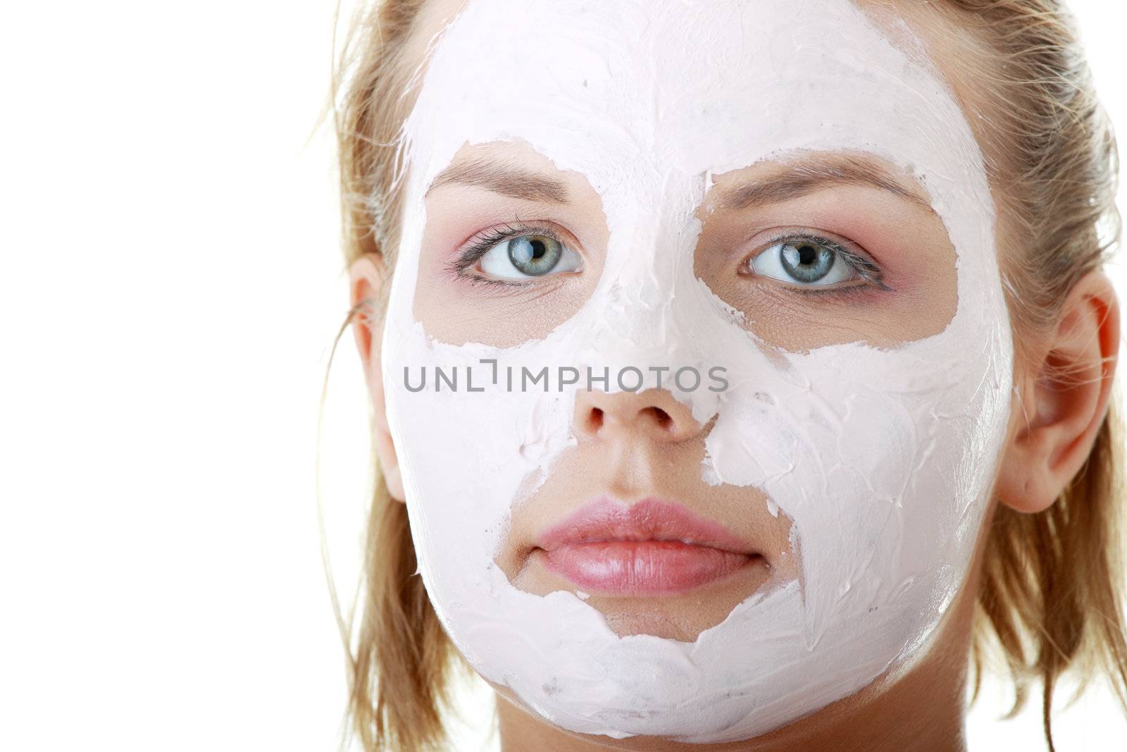 Cosmetics mask of clay on the young female face