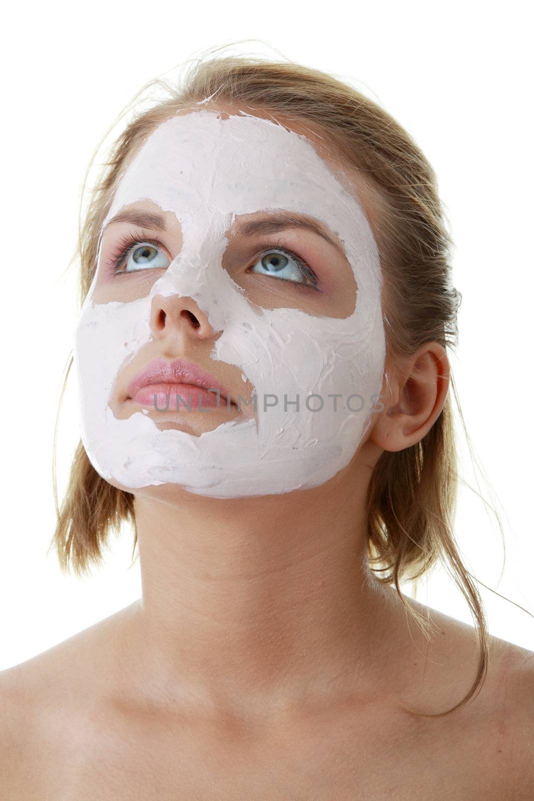 Cosmetics mask of clay on the young female face