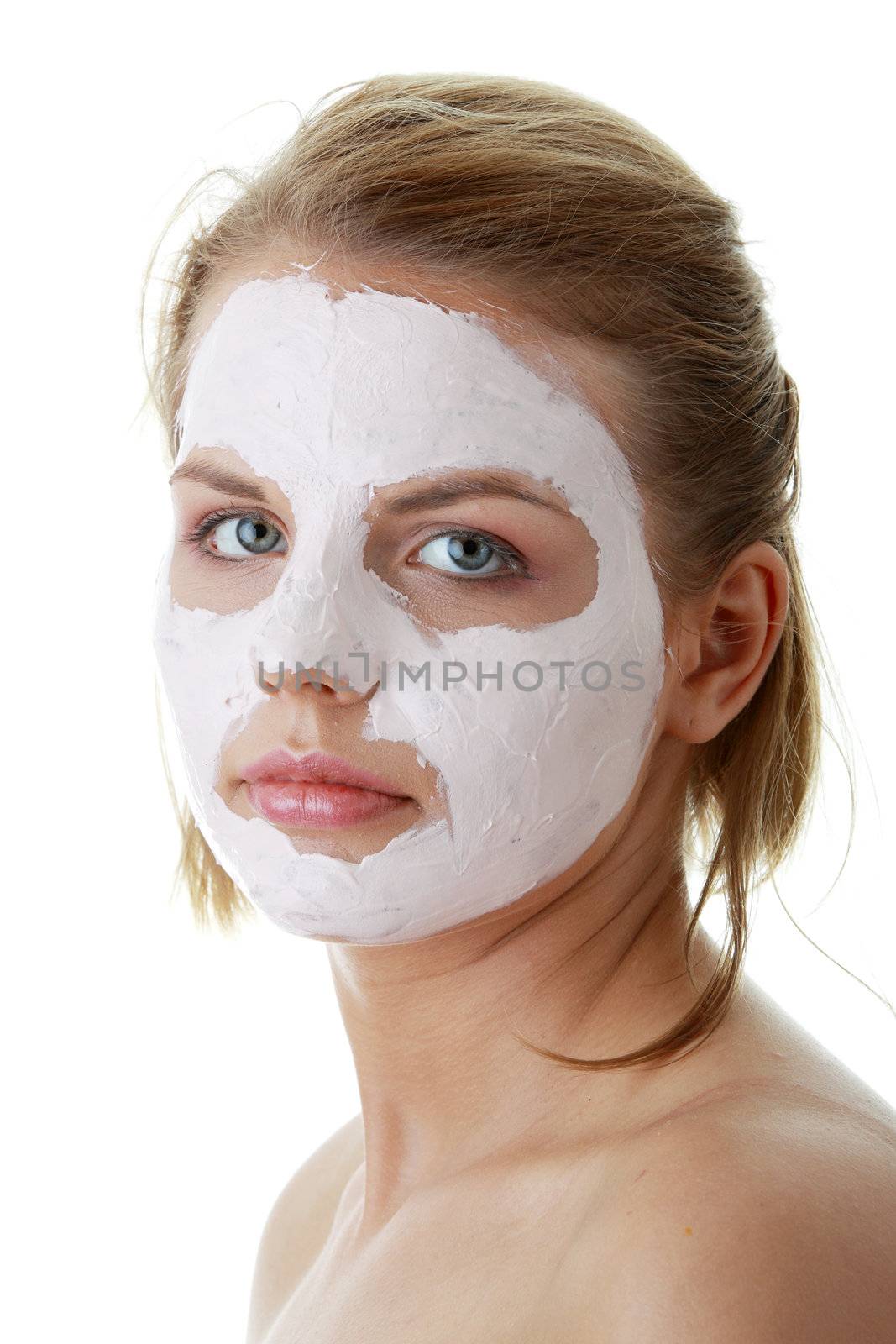 Cosmetics mask of clay on the young female face