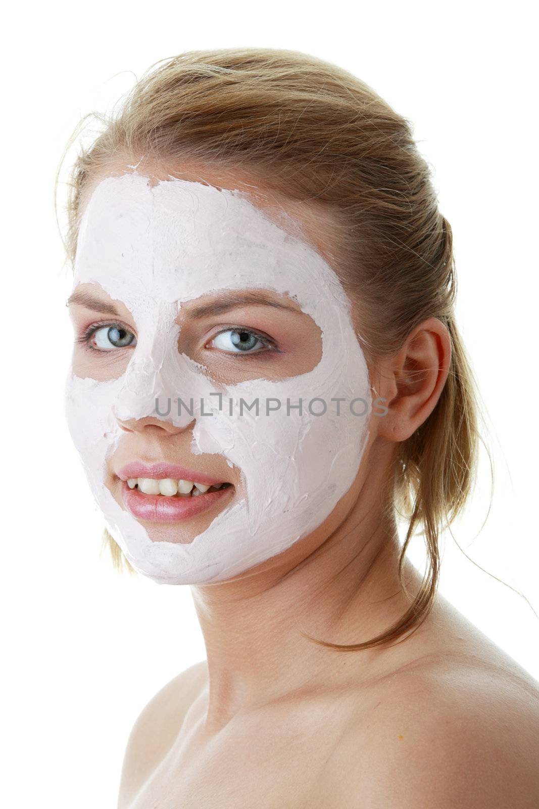 Cosmetics mask of clay on the young female face
