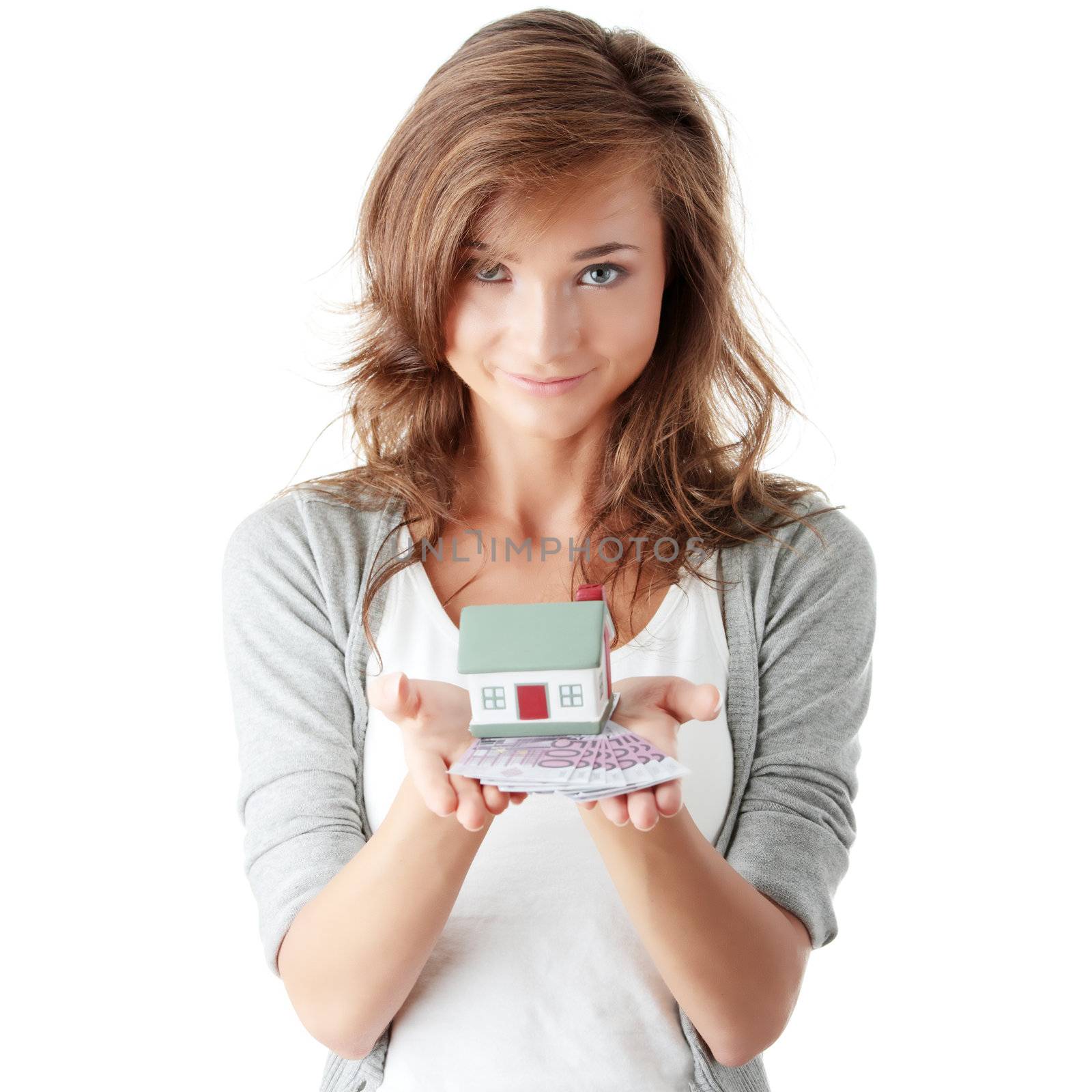 Woman holding euros bills and house model by BDS