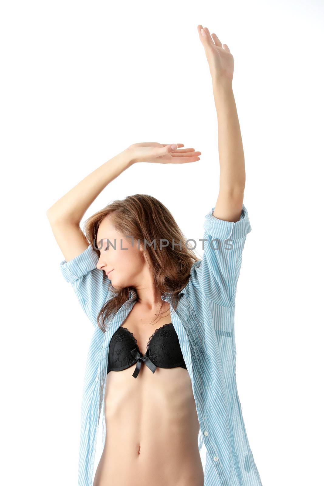 Young beautiful morning woman in big shirt and underwear stretching