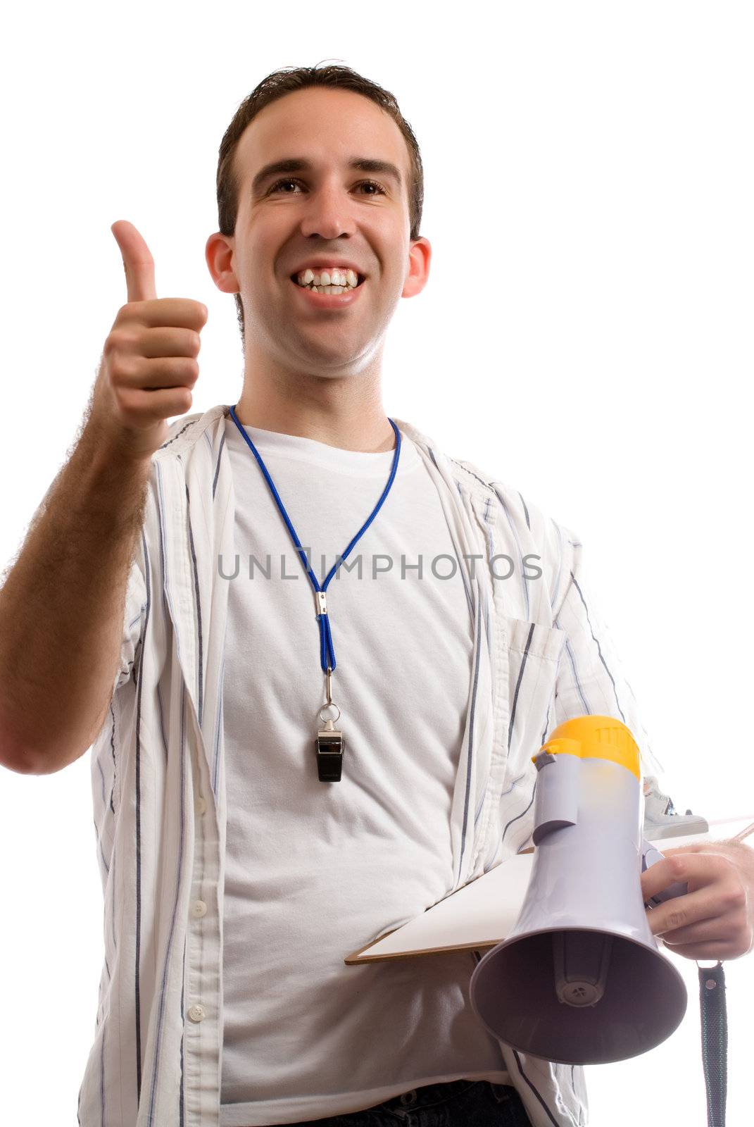 A young coach is giving his team a thumbs up, while holding his megaphone and clipboard