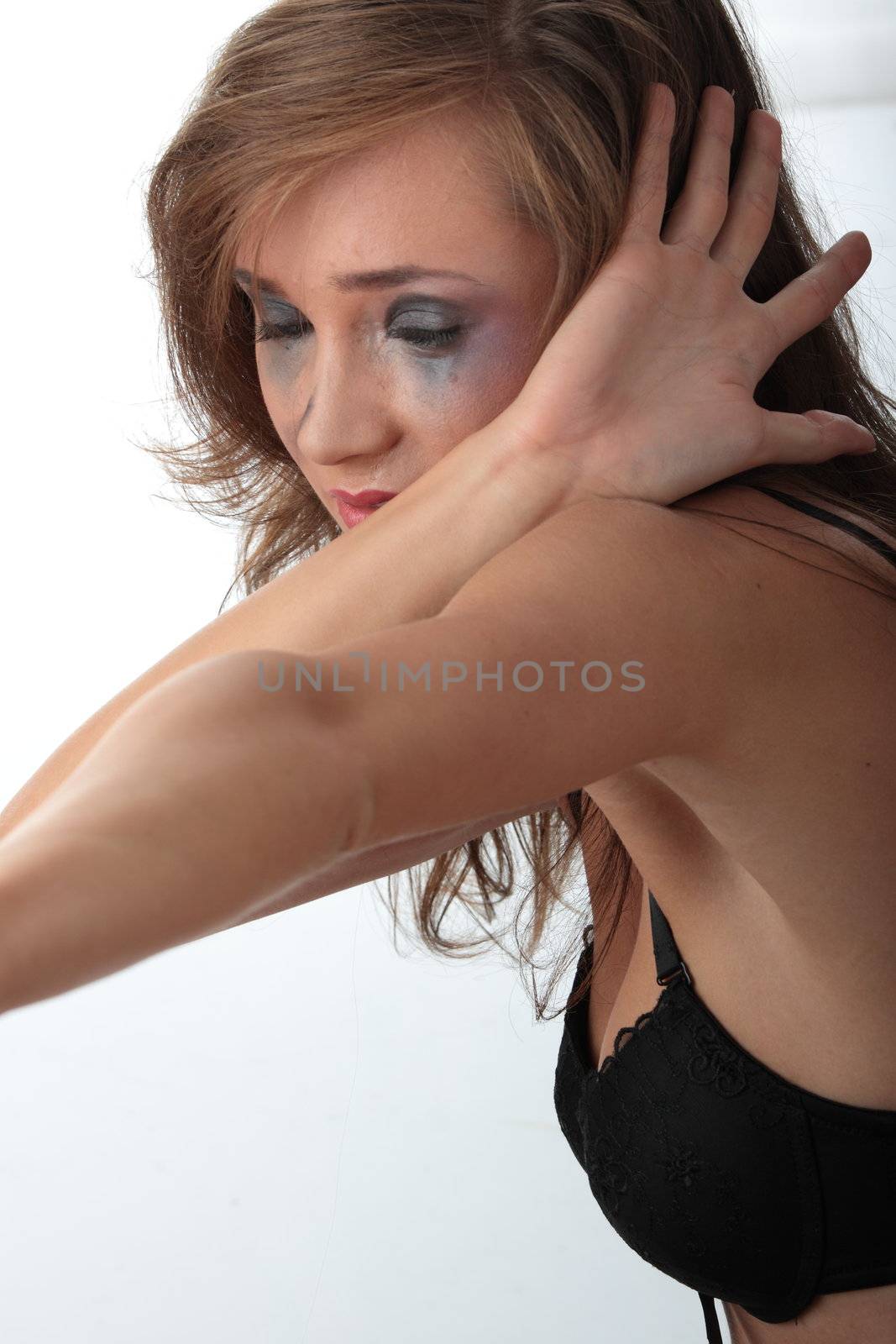 Emotional portrait of abused, crying, beautiful, young ,caucasian woman in underwear - violence concept