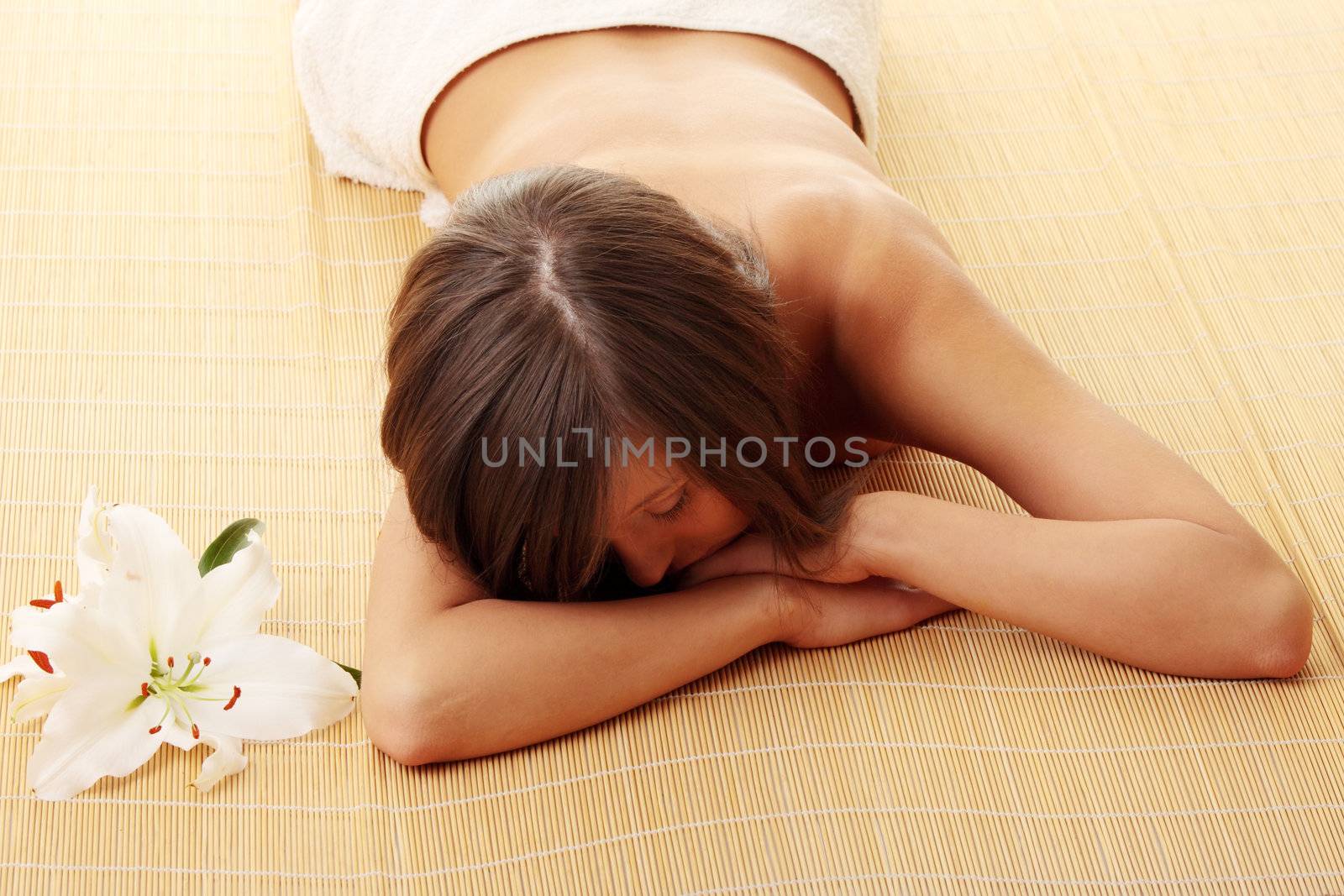 Young woman (teen girl) relaxing in massage